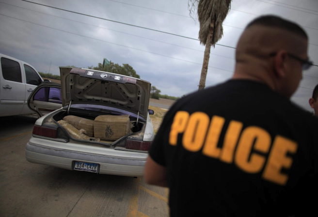 A car filled with bales of marijuana is seen at a police station in La Grulla, Texas March 28, 2013. When police tried to pull the car over, the driver led officers on a high speed pursuit, driving the car into the Rio Grande river. The driver abandoned the vehicle and fled back across the river and into Mexico. Brooks County has become an epicentre for illegal immigrant deaths in Texas. In 2012, sheriff's deputies found 129 bodies there, six times the number recorded in 2010. Most of those who died succumbed to the punishing heat and rough terrain that comprise the ranch lands of south Texas. Many migrants spend a few days in a "stash house", such as the Casa del Migrante, in Reynosa, Mexico, and many are ignorant of the treacherous journey ahead. Border Patrol agents and local and state law enforcement are inundated with not only an increase in the numbers of illegal immigrants, but drug smugglers as well. Picture taken March 28, 2013. REUTERS/Eric Thayer (UNITED STATES - Tags: CRIME LAW SOCIETY IMMIGRATION POLITICS DRUGS) ATTENTION EDITORS: PICTURE 19 OF 36 FOR PACKAGE 'LIFE ON A DEADLY BORDER' SEARCH 'BROOKS MIGRANTS' FOR ALL IMAGES