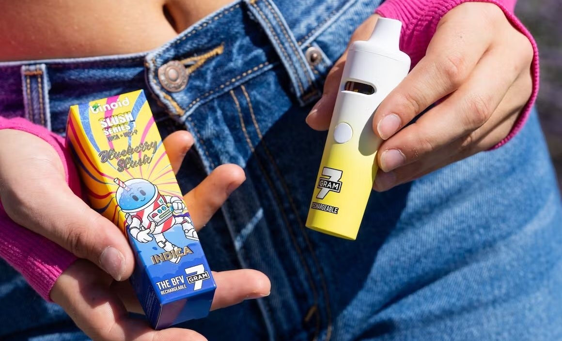 woman holding a vape and the package in both hands