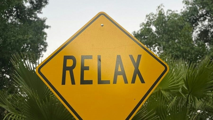 relax sign in the middle of a street