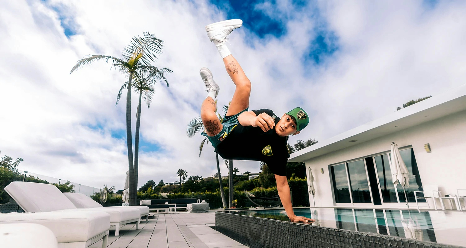 man doing a jump while holding a vape