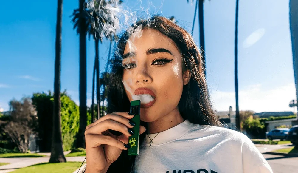 woman smoking from a vape