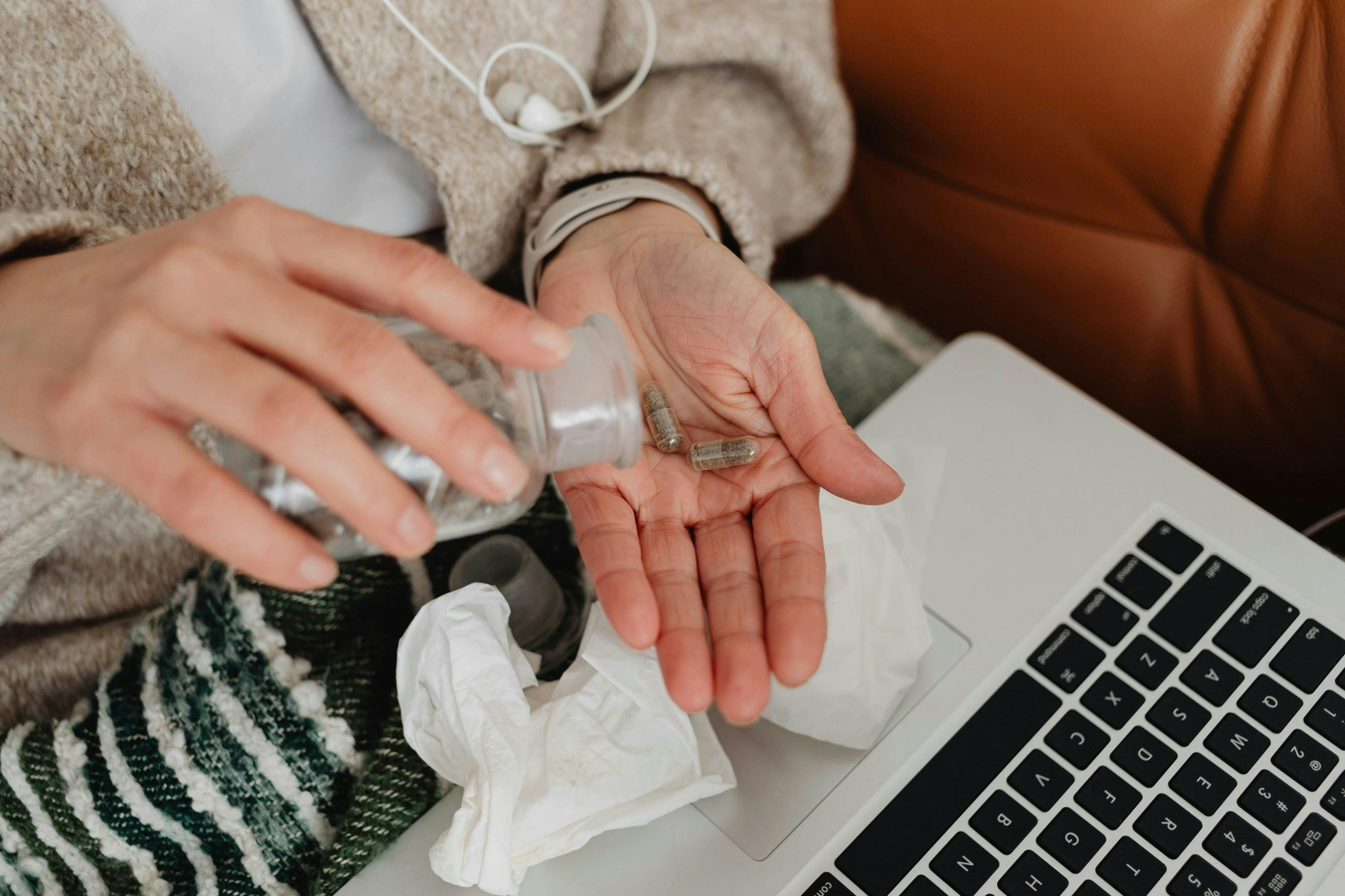 Woman Using a Laptop and Taking Pills