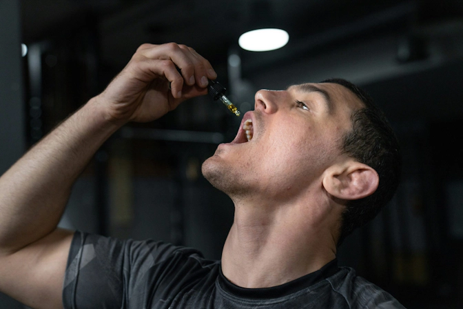 Man holding CBD oil dropper
