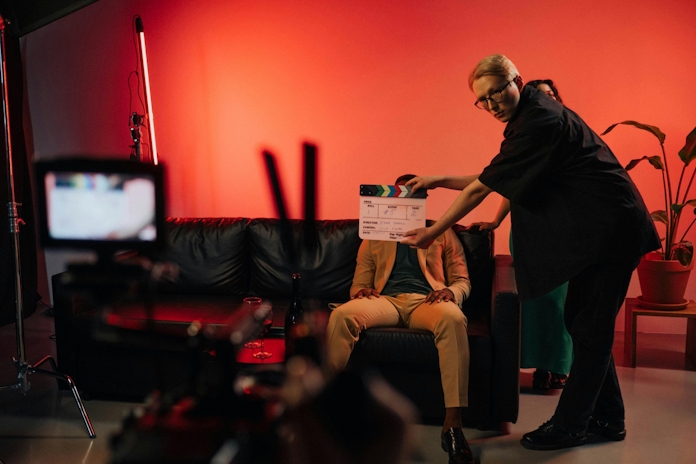 A woman holding a clapperboard