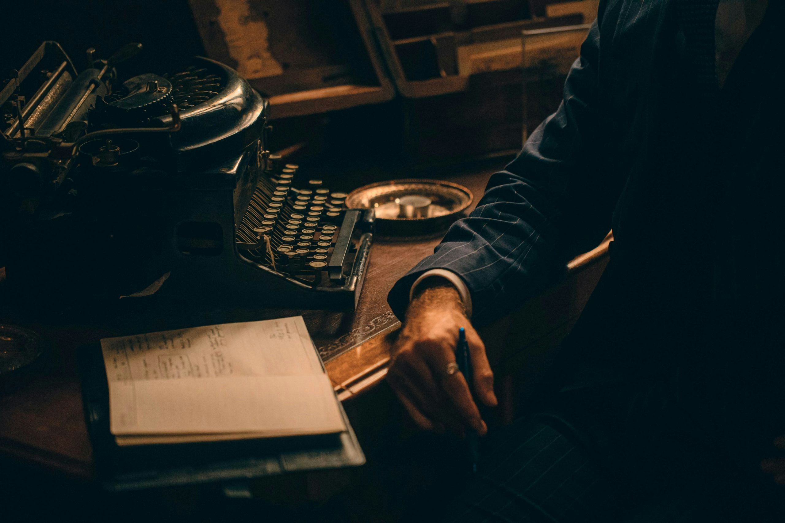 Man sitting at a desk with an old typewriter