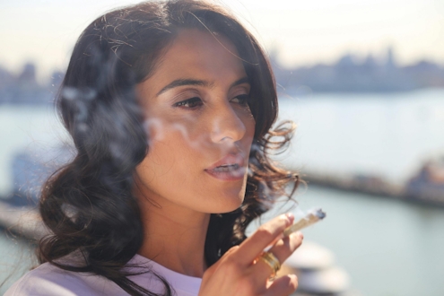 Woman smoking a joint in close-up photography