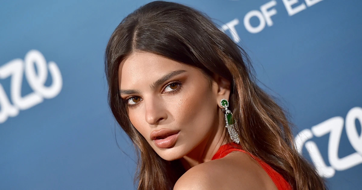 Emily Ratajkowski posing confidently in front of the camera during an event