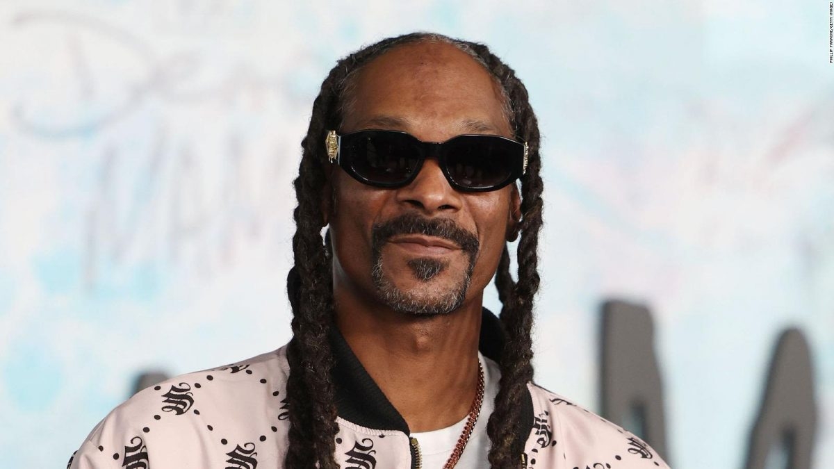 Snoop Dogg posing for the camera during a public appearance.