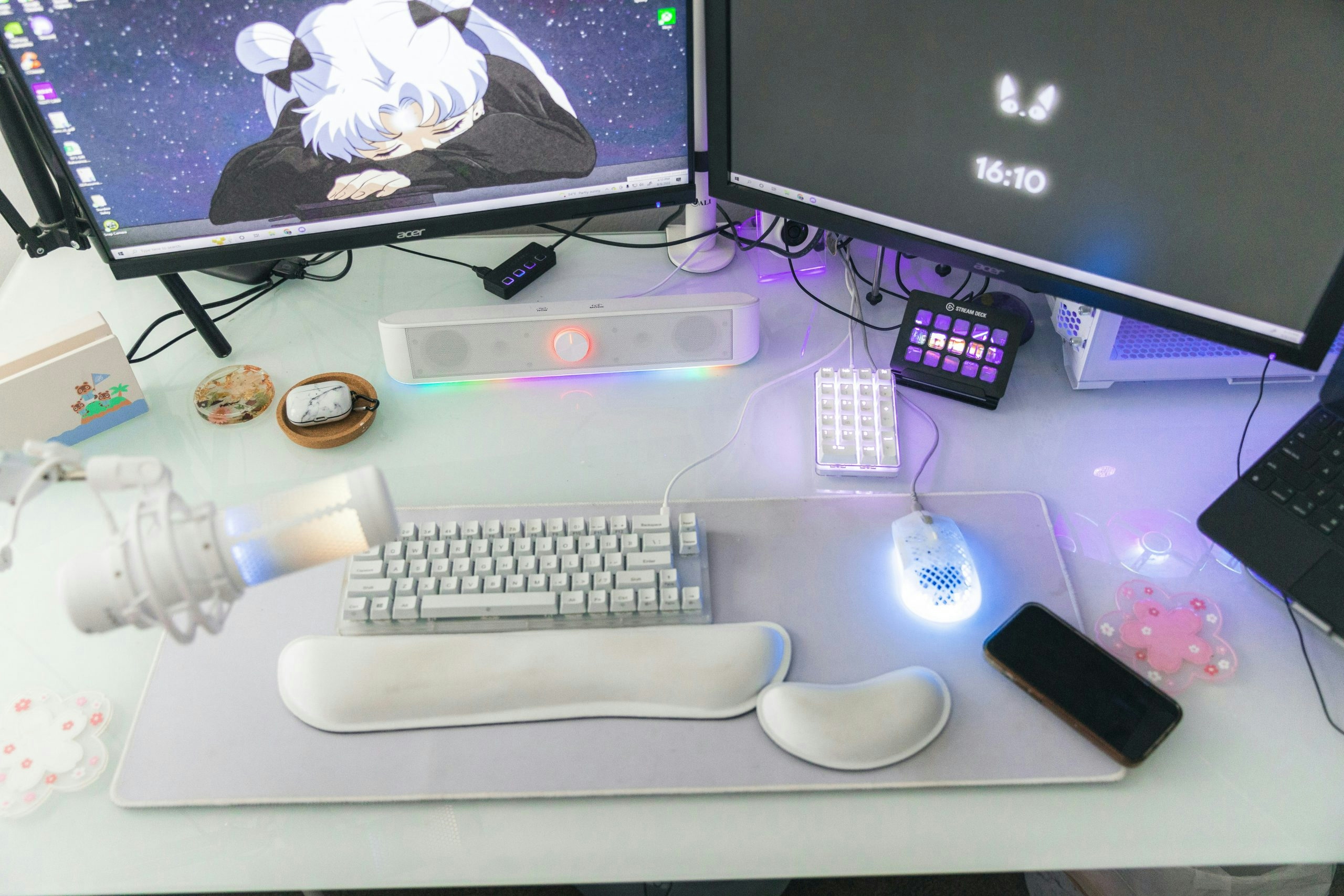 Aesthetic streaming setup with a gaming desk, monitors, and colorful ambient lighting