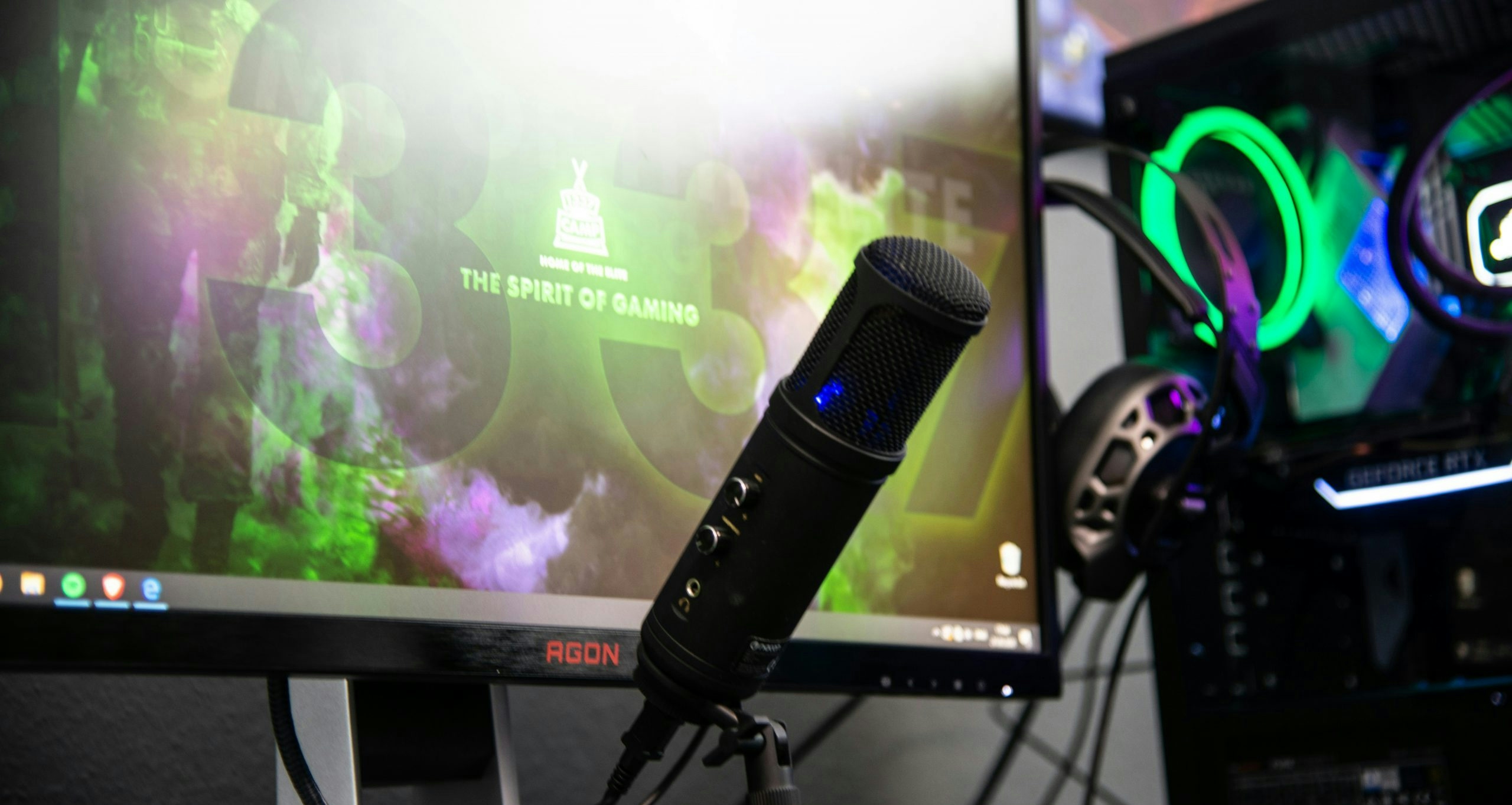 Professional streamer setup with a gaming PC, monitors, microphone, and LED lighting