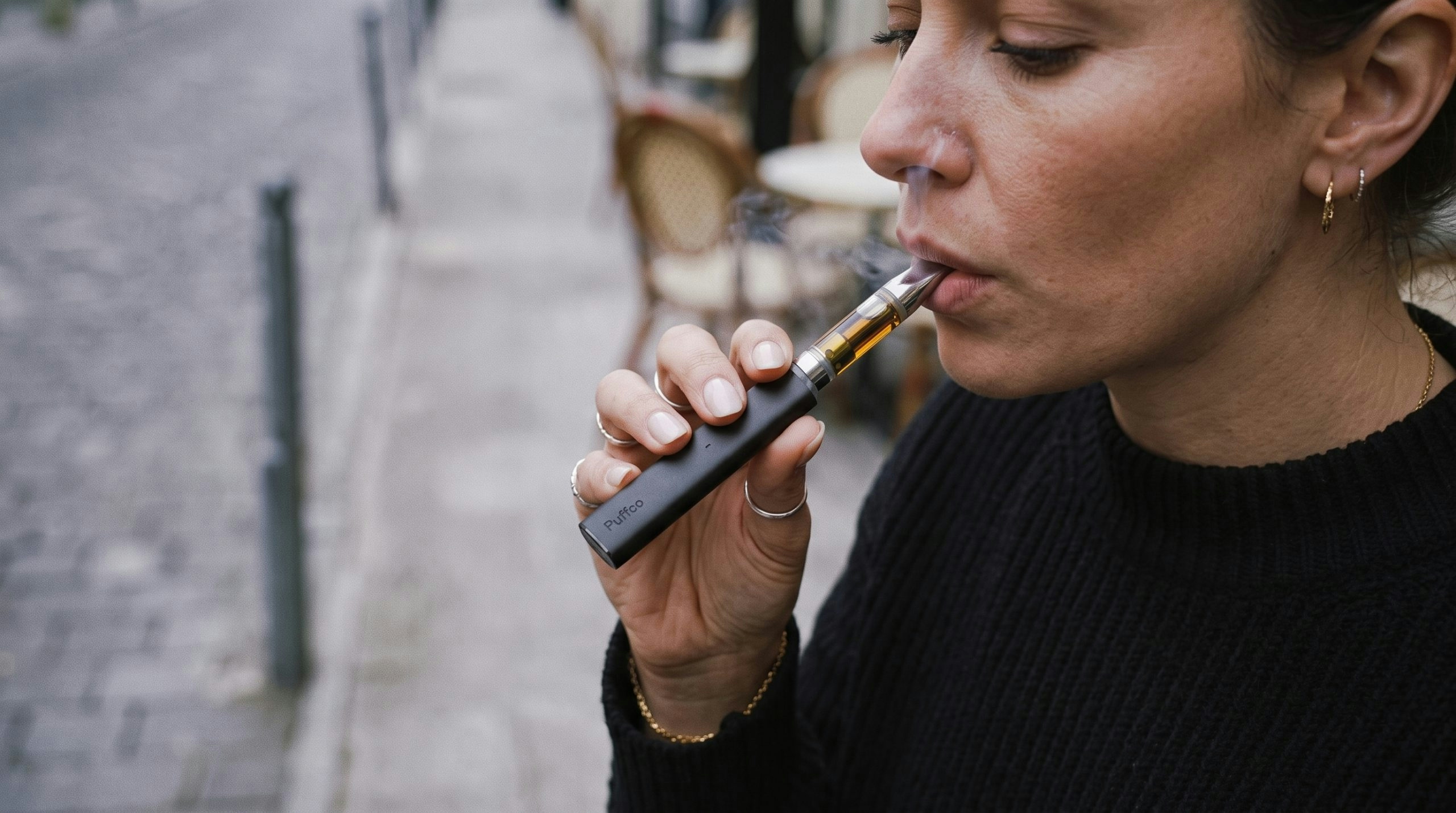 woman using a weed cartridge