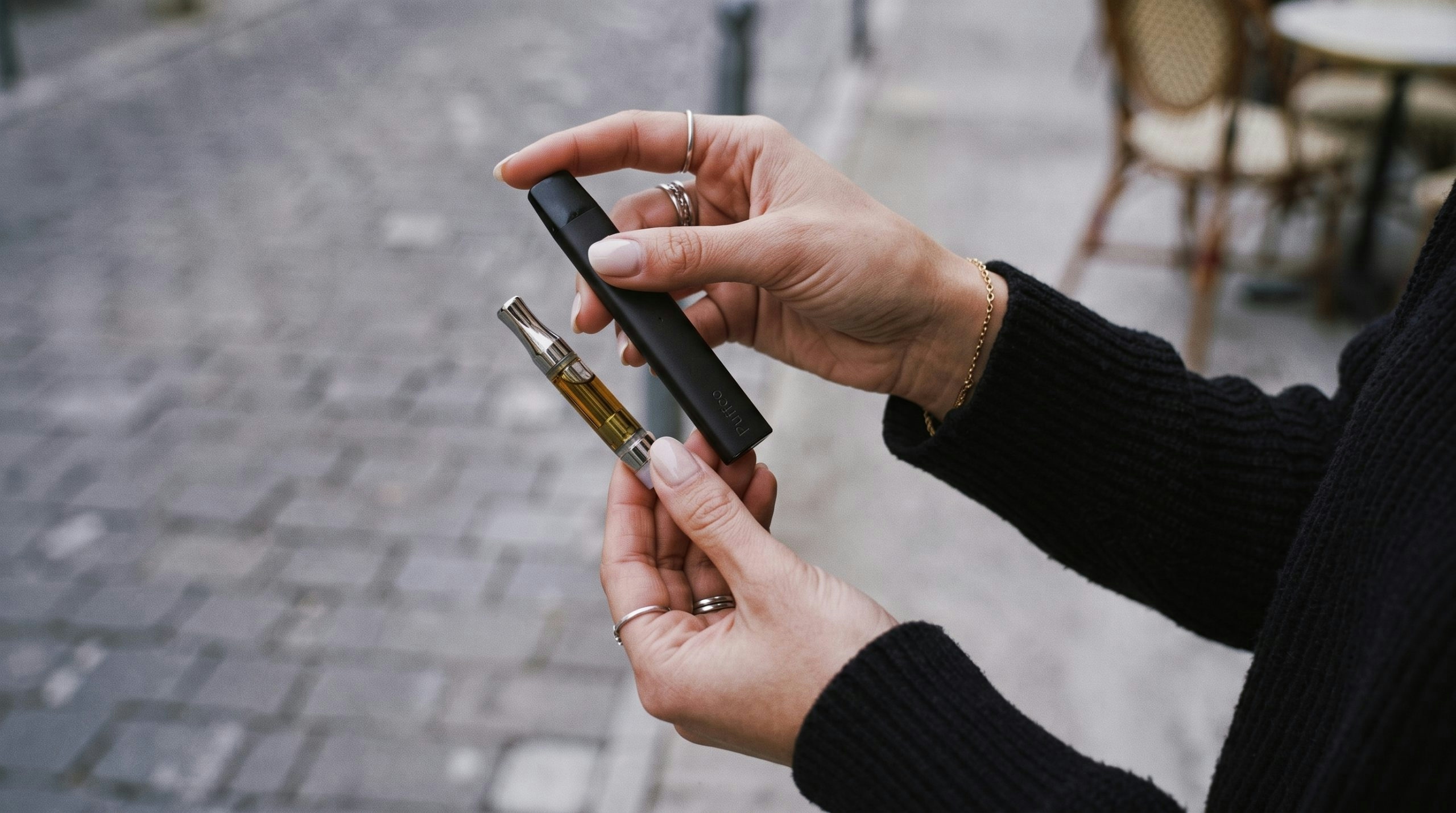 woman comparing a disposable vape vs a cart