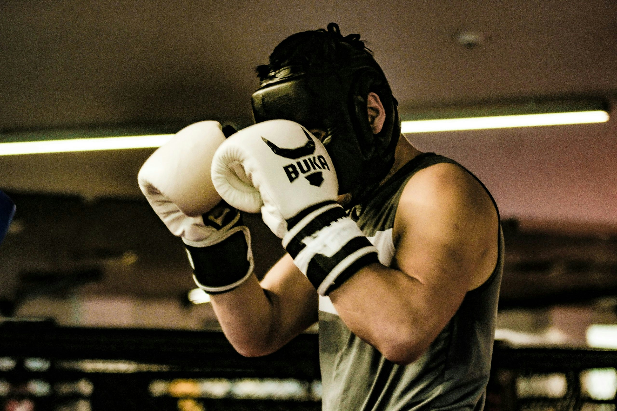 Person wearing full boxing gear during a training session