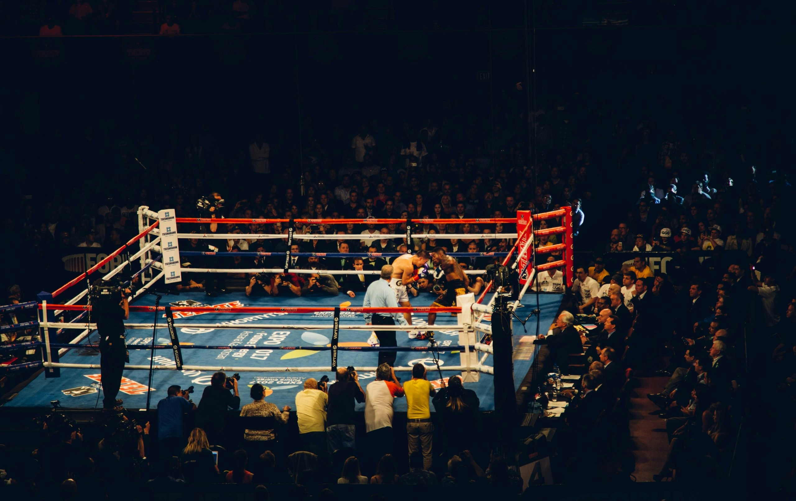 Two professional boxers competing during an intense boxing match