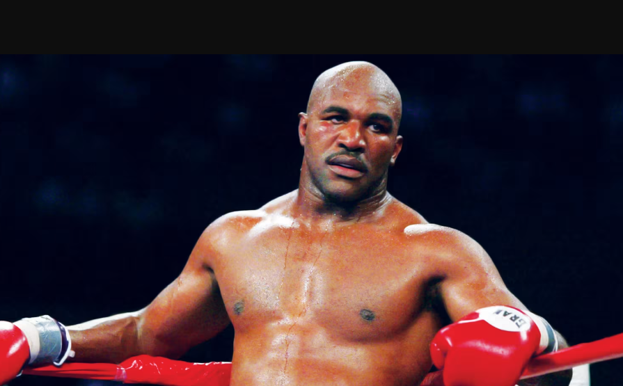 Evander Holyfield in a professional boxing environment, wearing boxing gear inside the ring