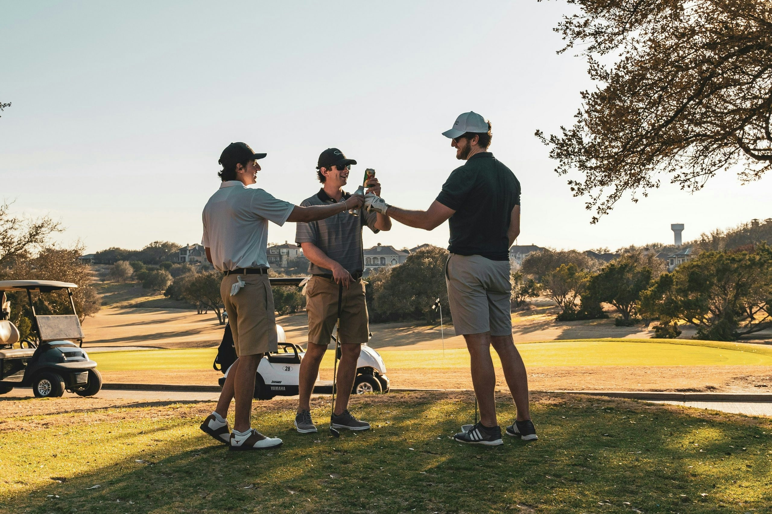 Group of friends enjoying a round of golf on a sunny course