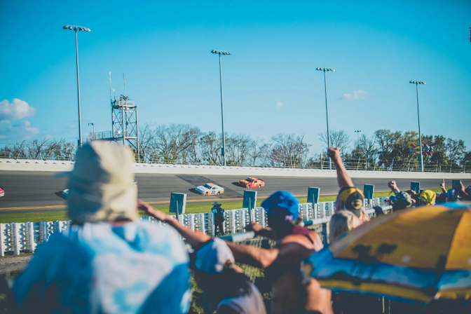 Fans cheering during a NASCAR race at the speedway
