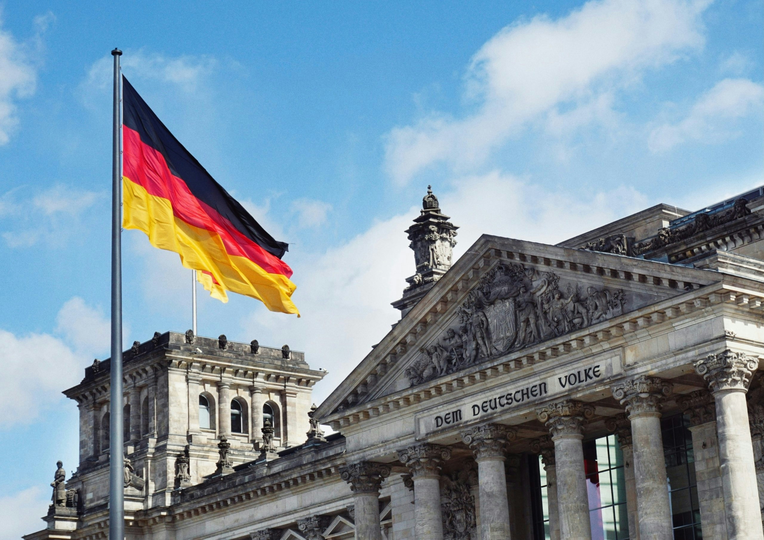 germany flag waving near a monument