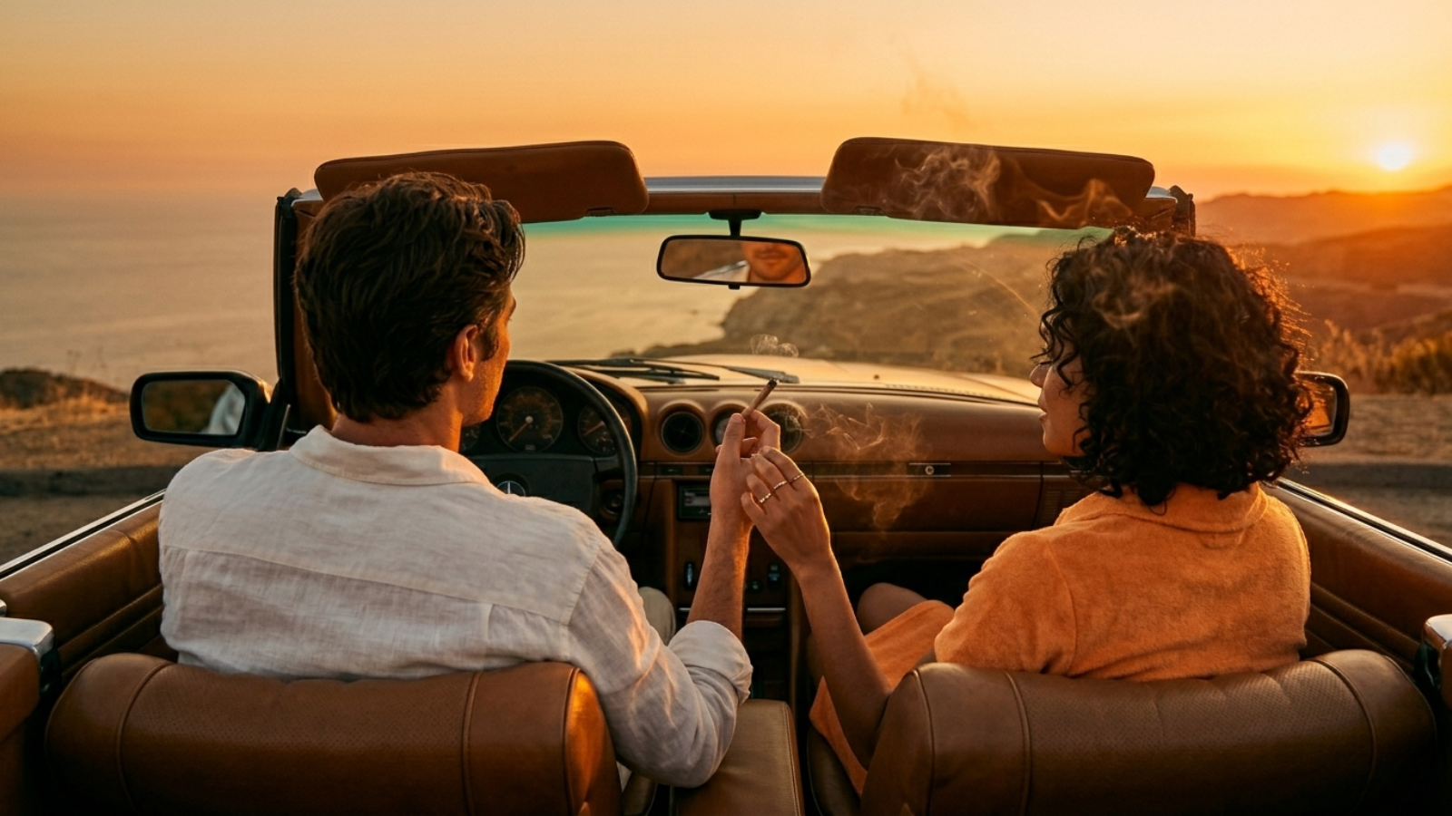 Couple passing a joint in a convertible at sunset from backseat perspective