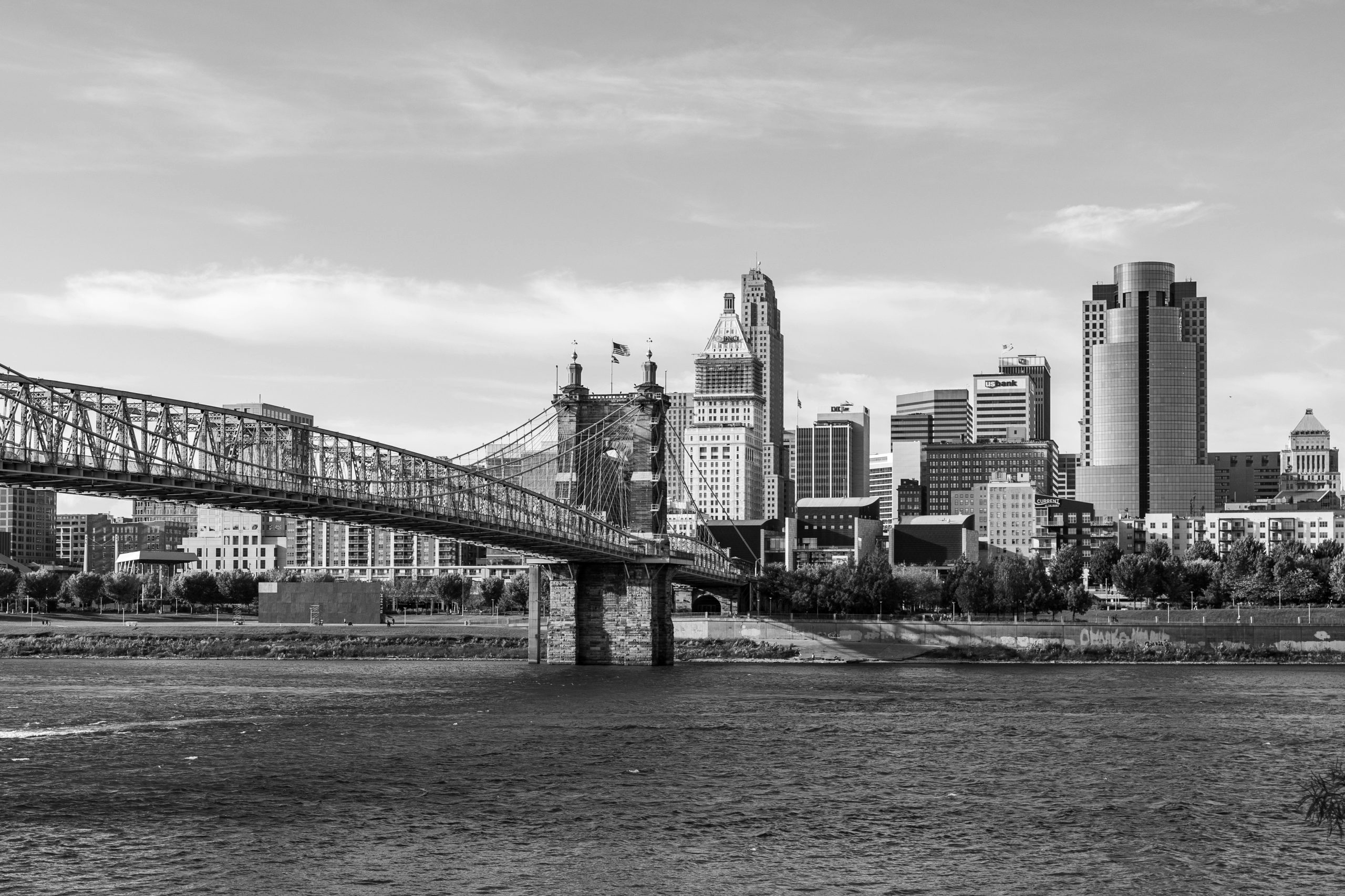 black and white image of a bridge and some buldings