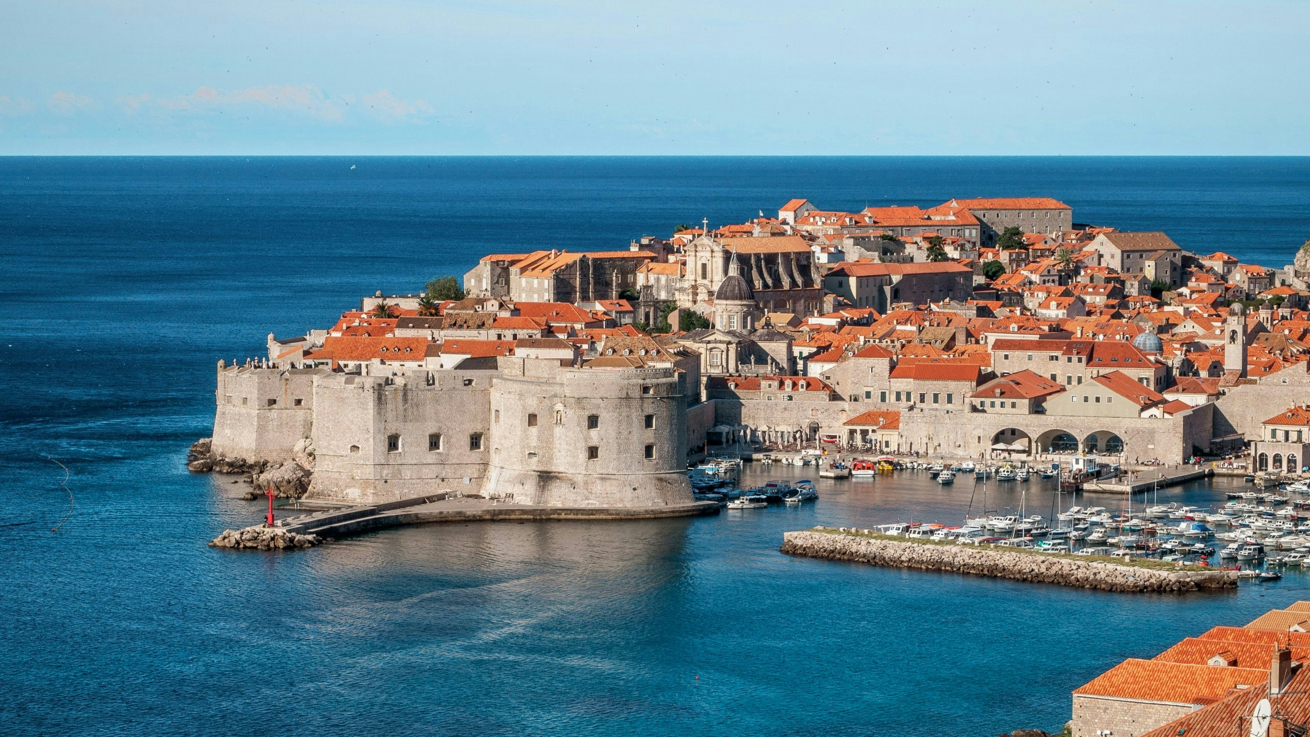 Aerial landscape of Croatia featuring coastal towns, islands, and clear blue waters