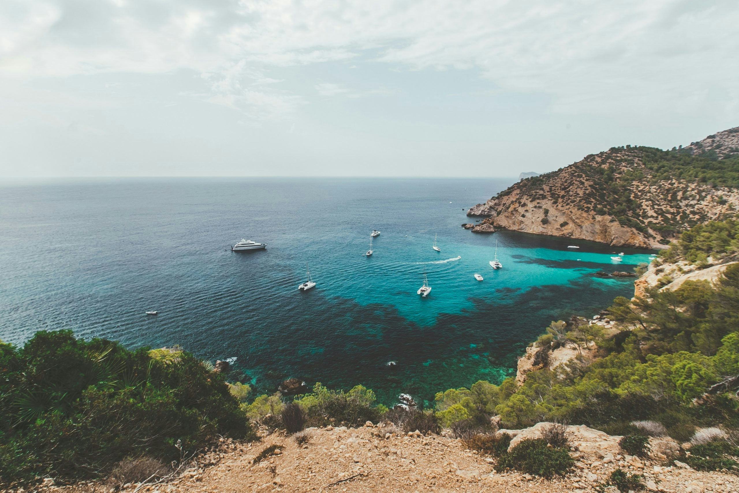 Mediterranean beach in Mallorca surrounded by dramatic coastal scenery