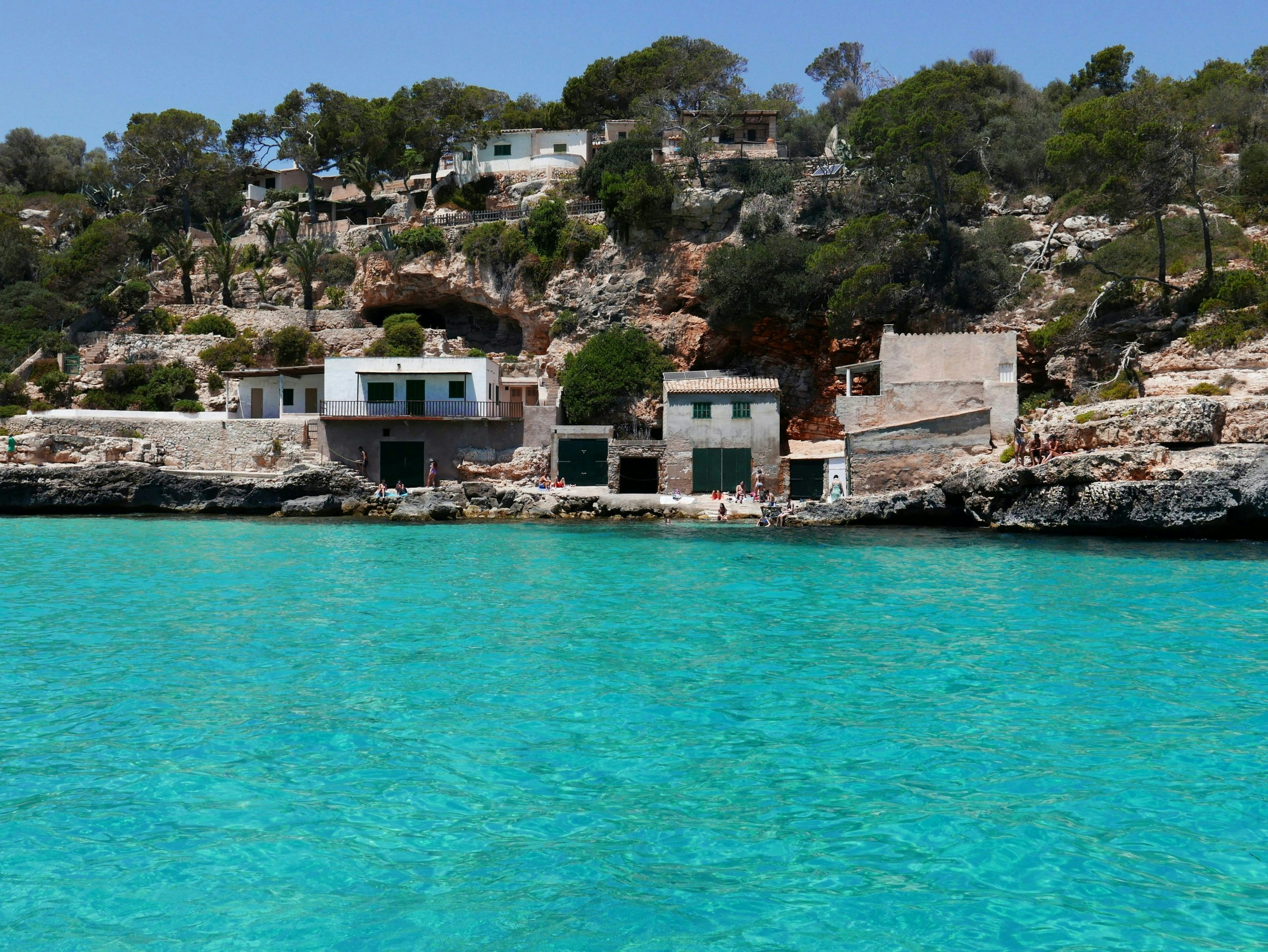 Scenic coastline in Mallorca featuring rocky cliffs and a secluded beach