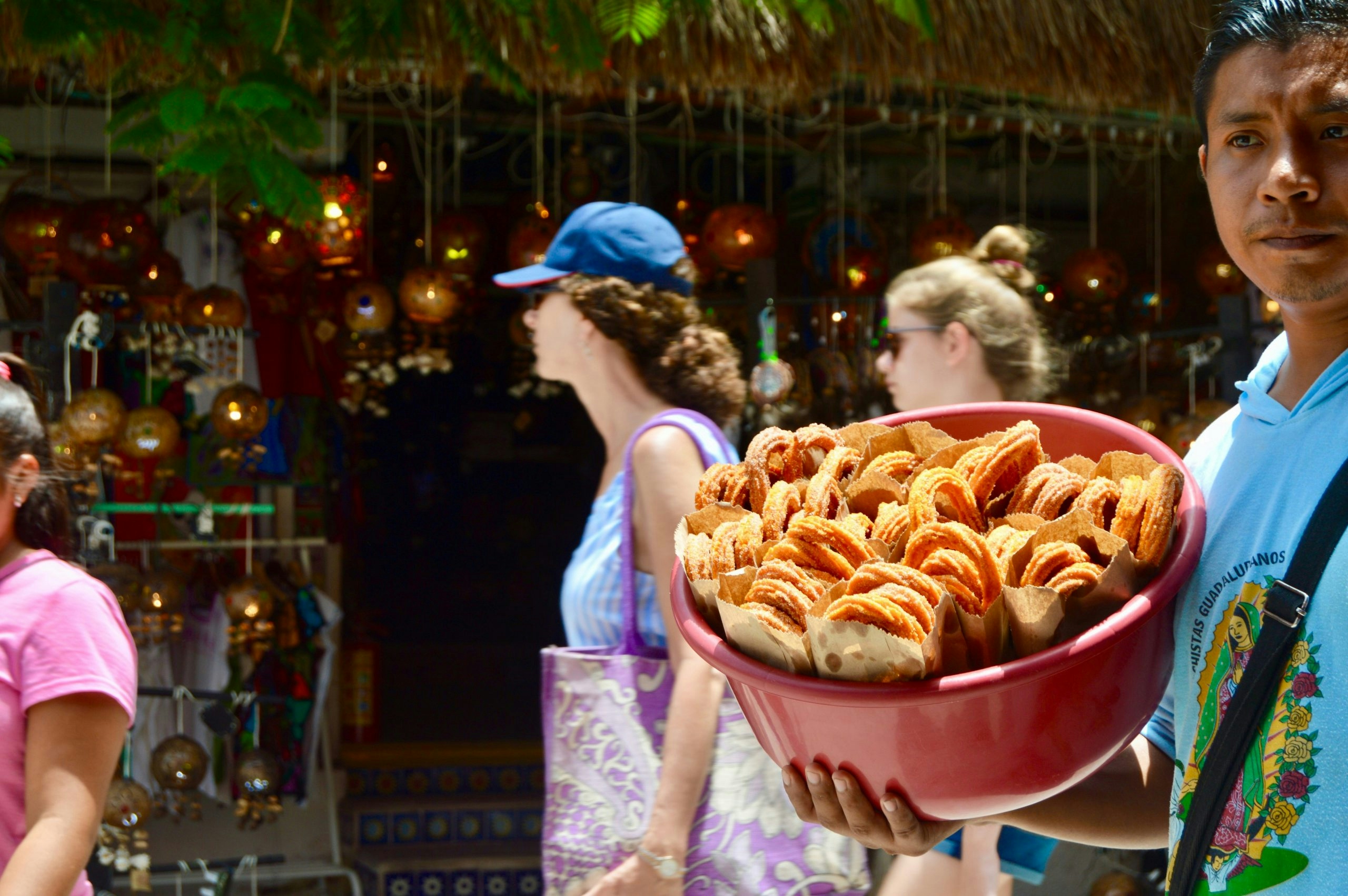 Bustling pedestrian street in Playa del Carmen featuring local businesses