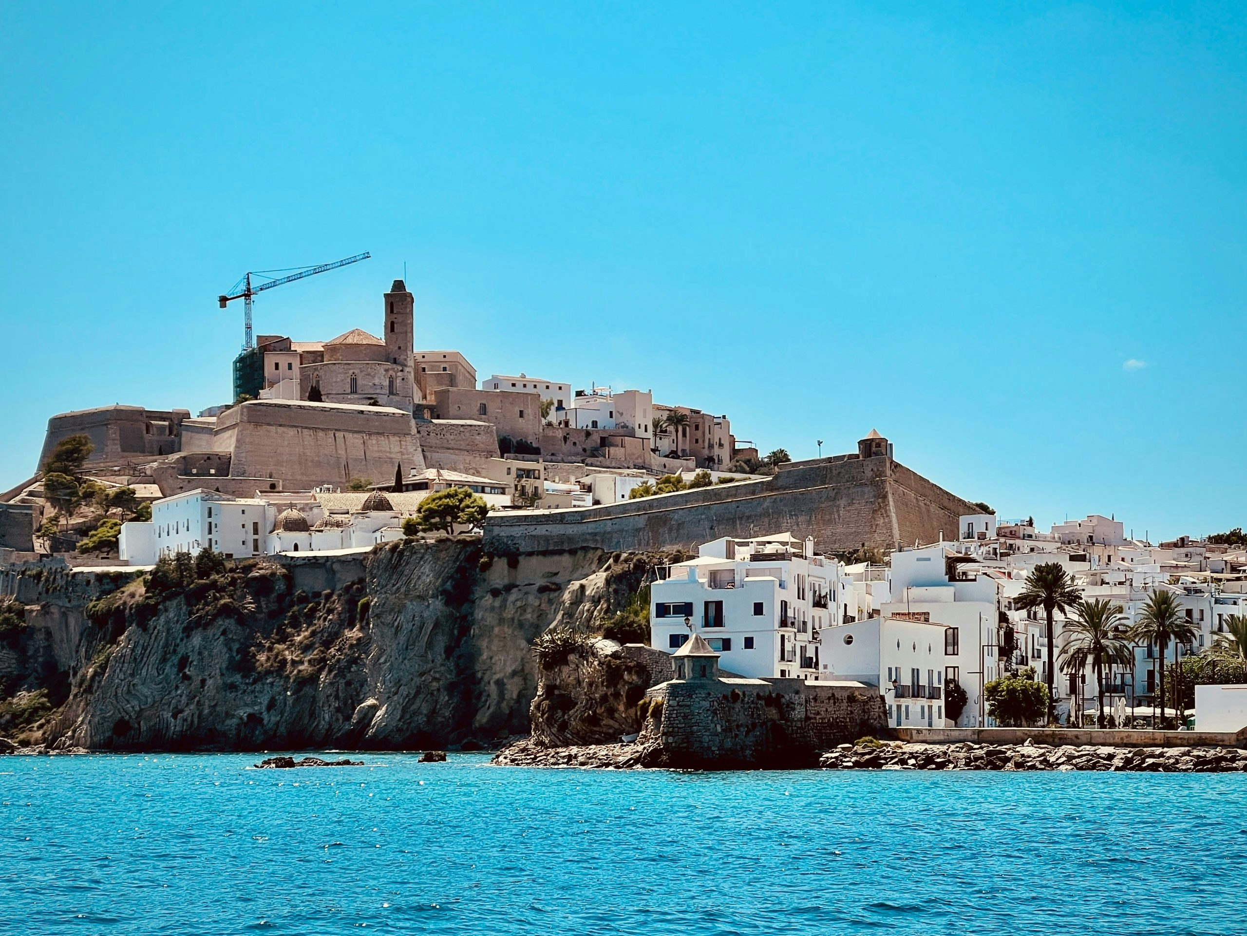 Panoramic view of Ibiza's coastline featuring turquoise waters and rugged cliffs