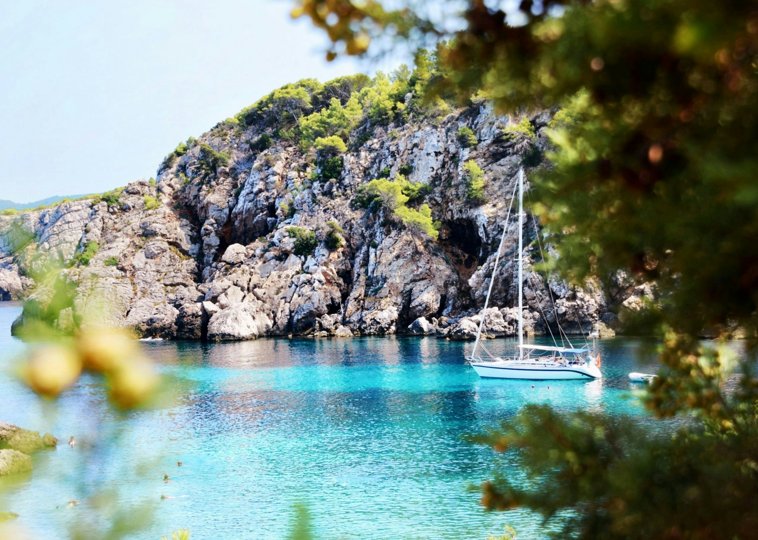Hidden cove in Ibiza with crystal-clear water and dramatic coastal scenery