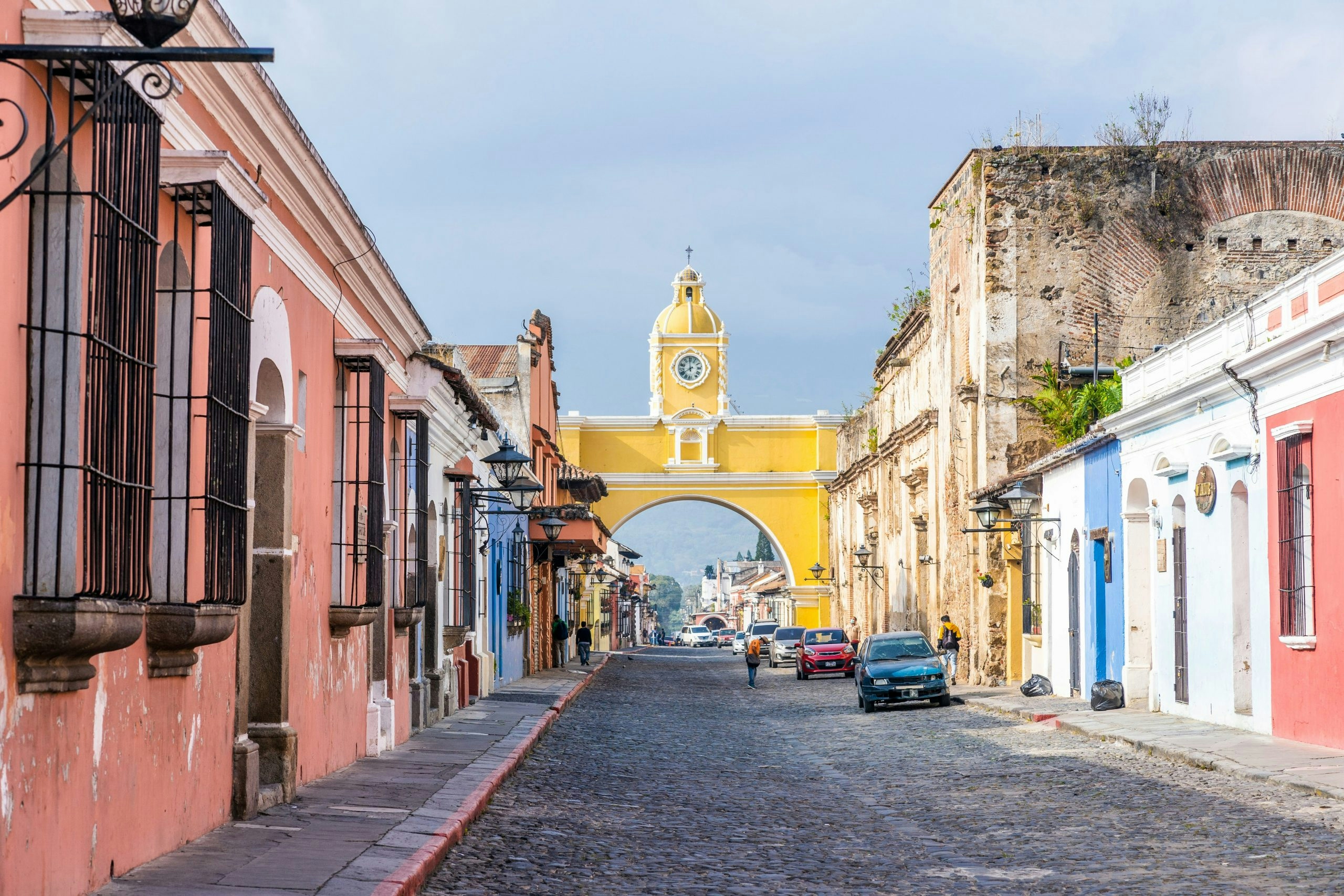 Colorful colonial street in Antigua Guatemala with Volcán de Agua in the background