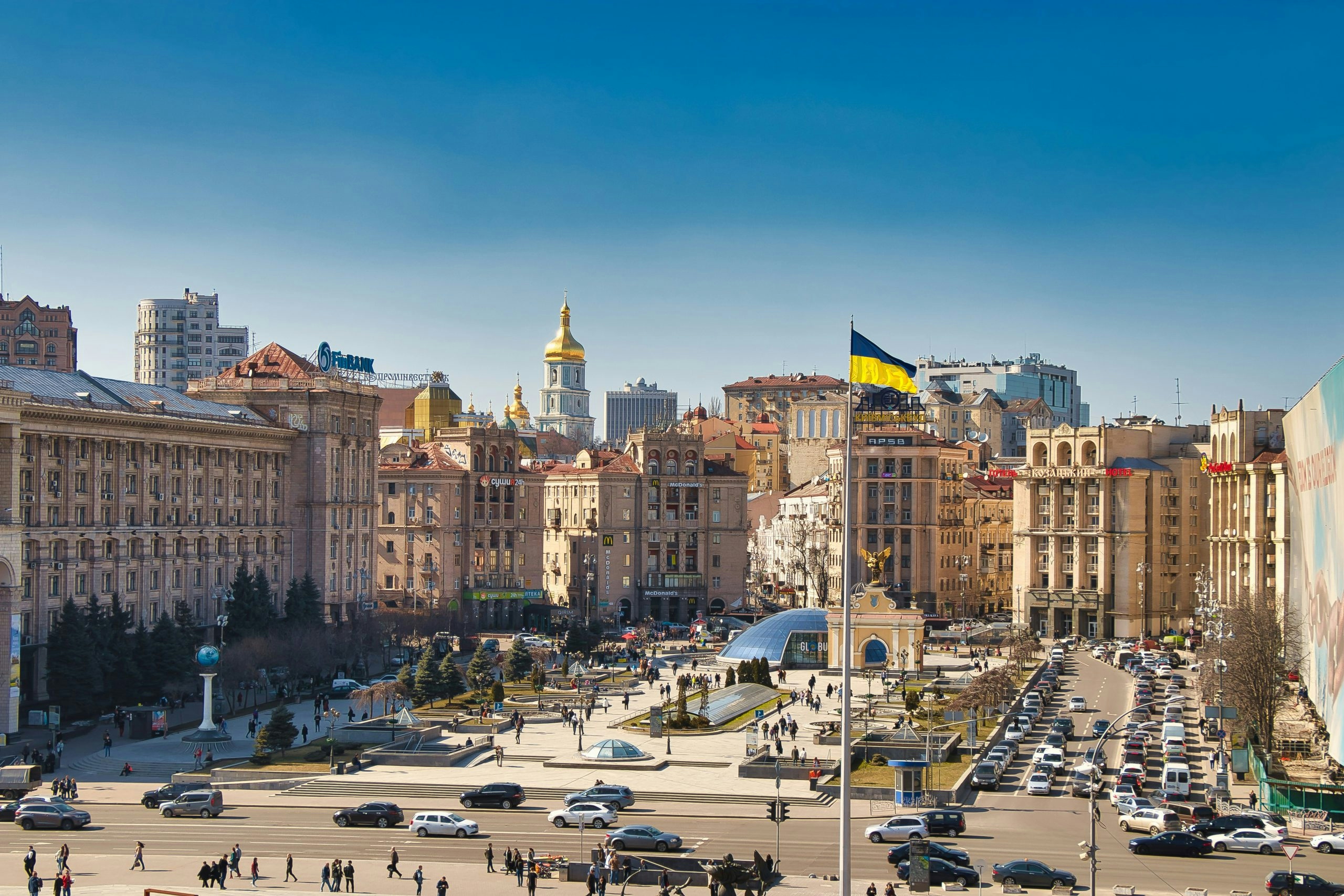 Cityscape of Kyiv under a clear blue sky