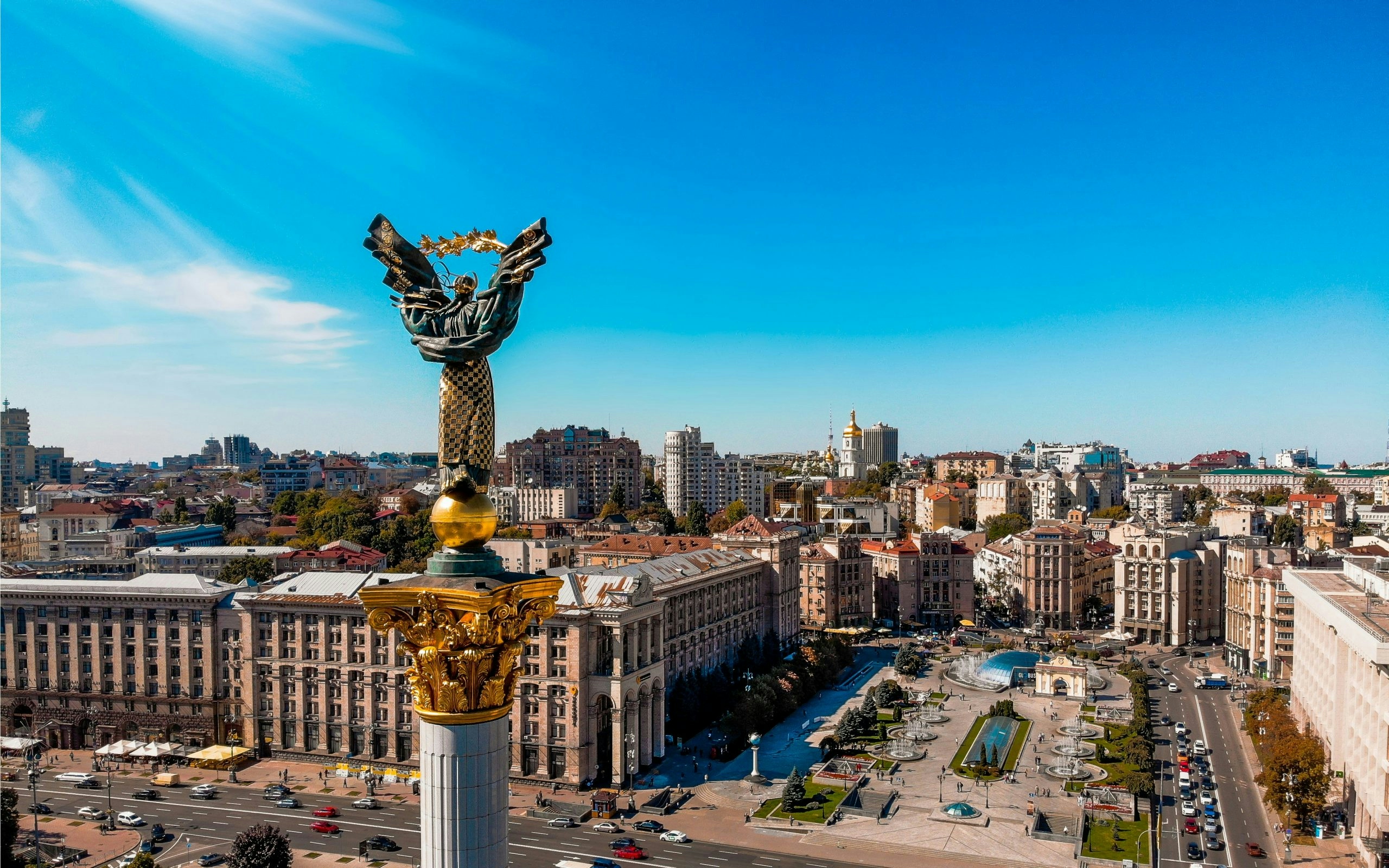 Cityscape of Kyiv under a clear blue sky