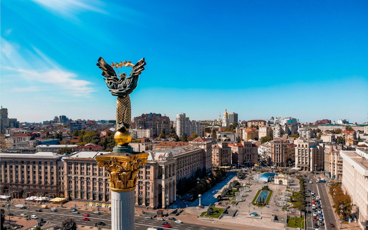 Cityscape of Kyiv under a clear blue sky
