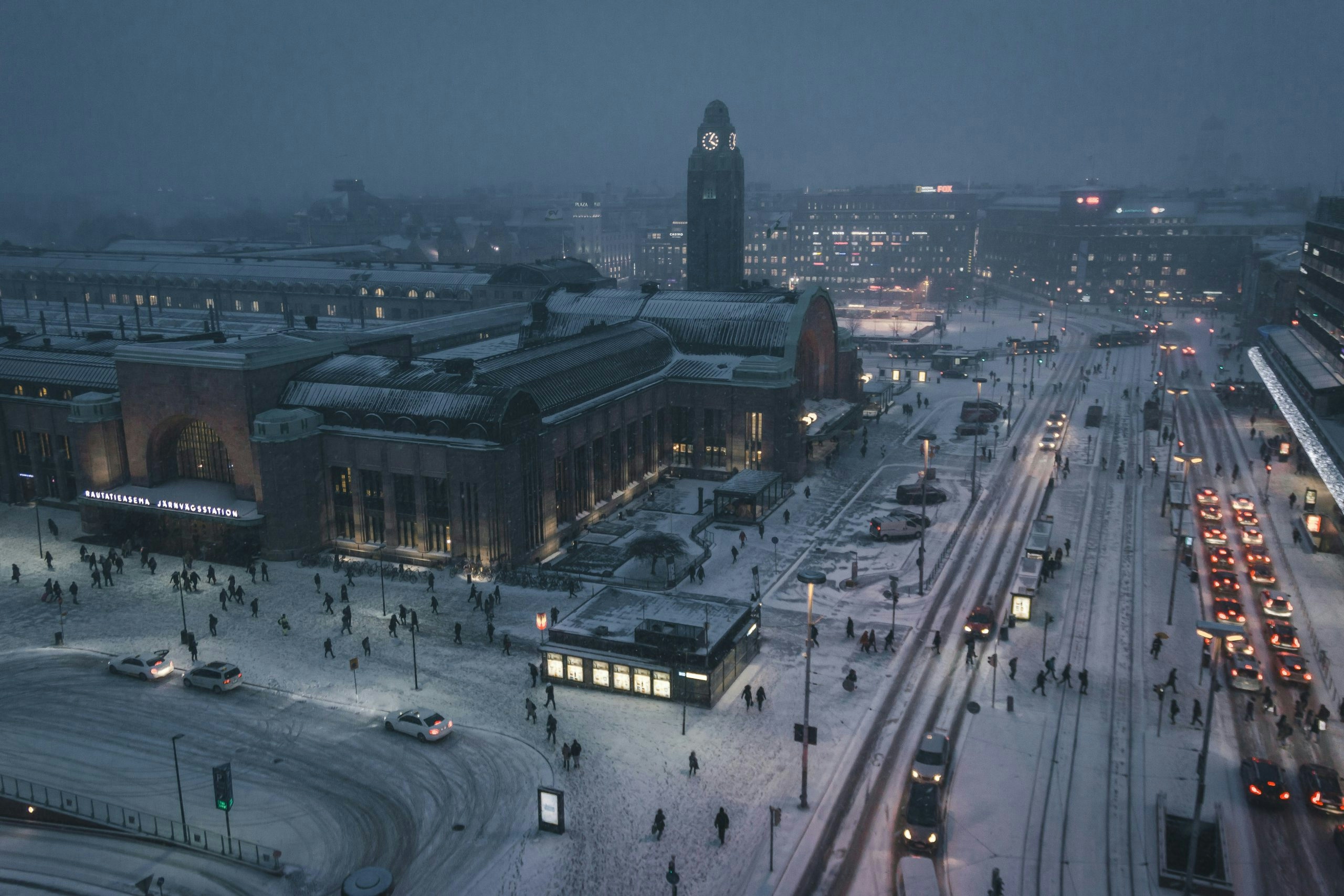 Snowy boulevard in Helsinki with an electric tram and historic Scandinavian architecture