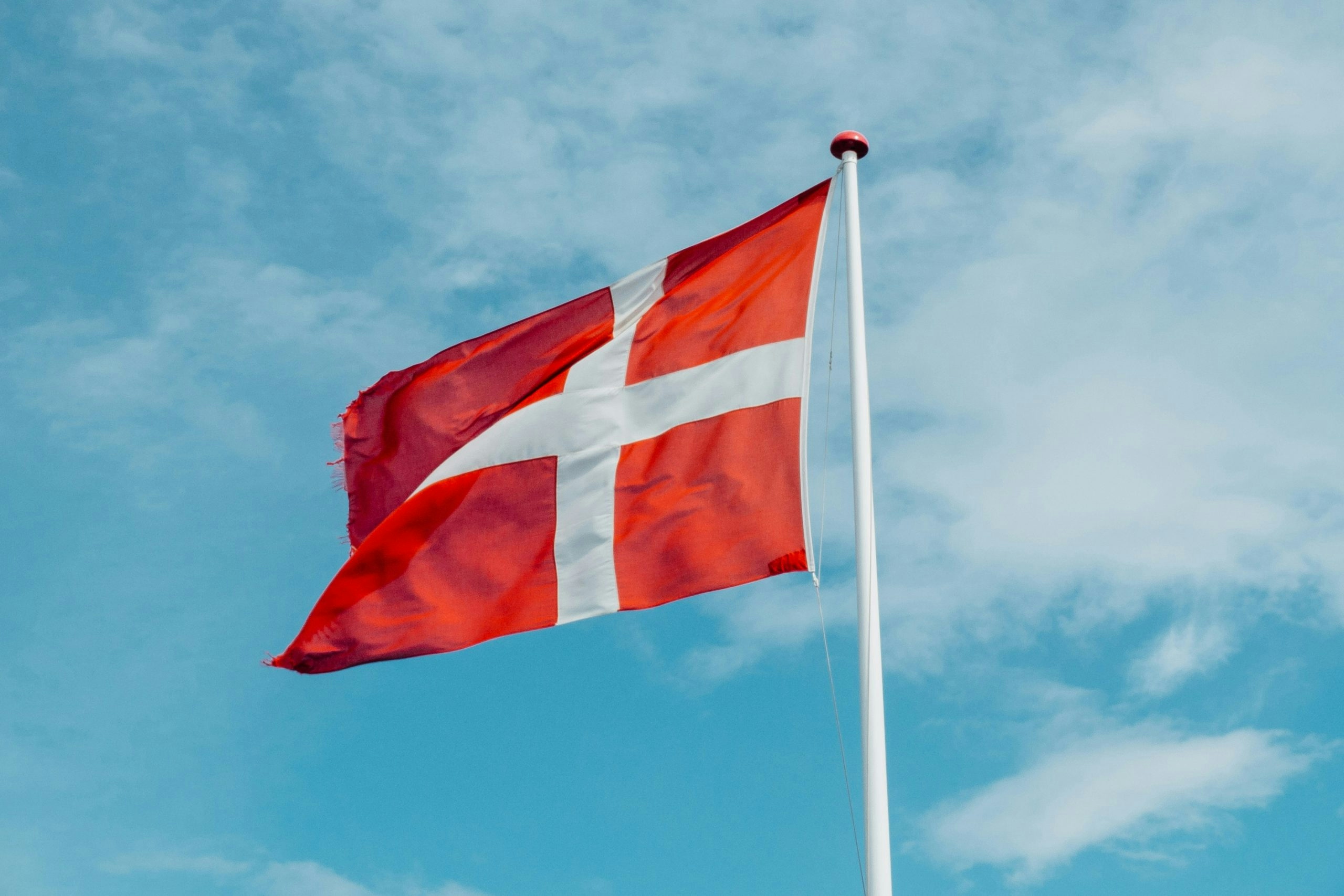 The Danish flag waving against a clear sky