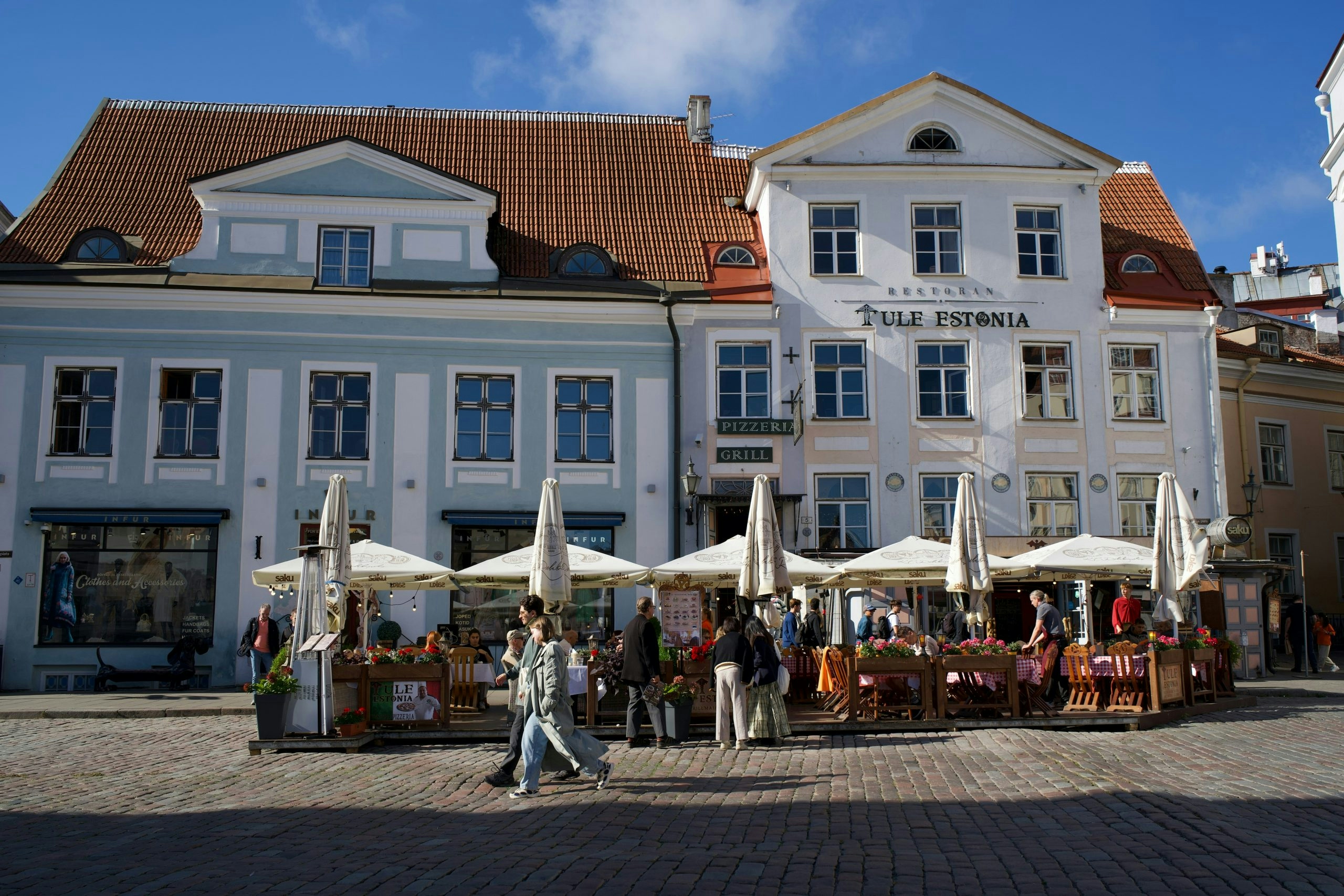 A traveler walking through Estonia's capital city while learning about local cannabis laws and where to buy weed in Estonia