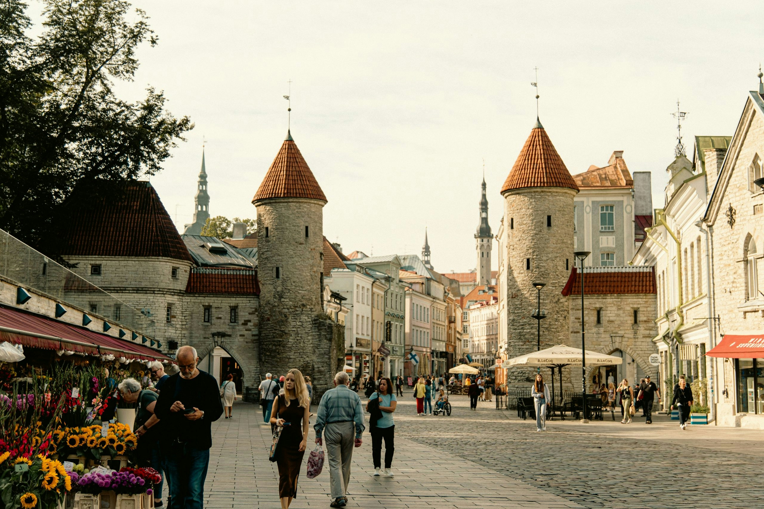 People gathered in a public square surrounded by historic Estonian architecture