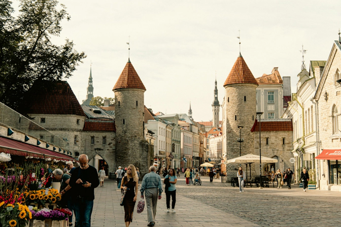 People gathered in a public square surrounded by historic Estonian architecture