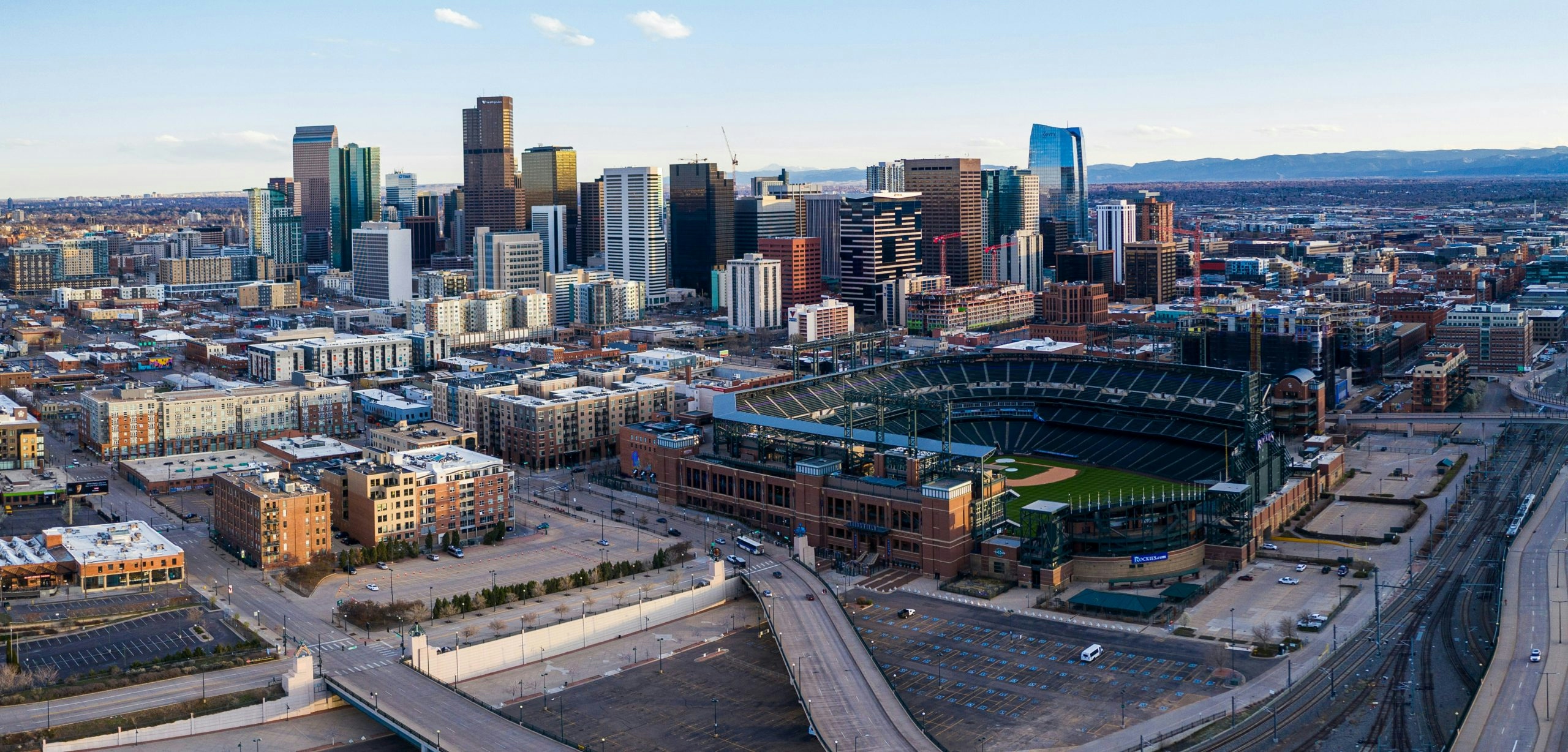 Panoramic view of the Denver skyline with the Rocky Mountains in the background