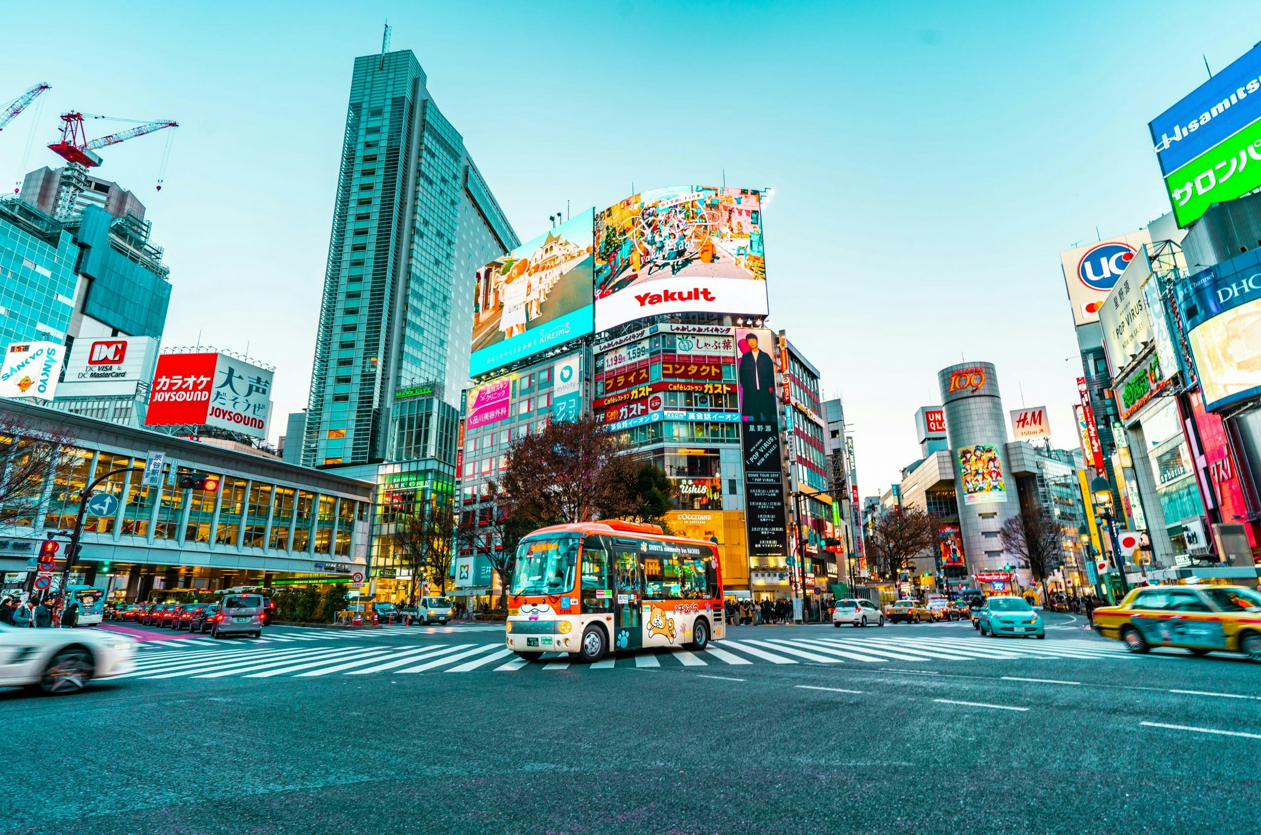 Busy street scene at Shibuya Crossing with pedestrians and bright city lights