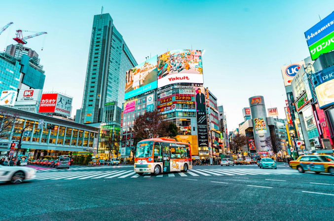 Busy street scene at Shibuya Crossing with pedestrians and bright city lights