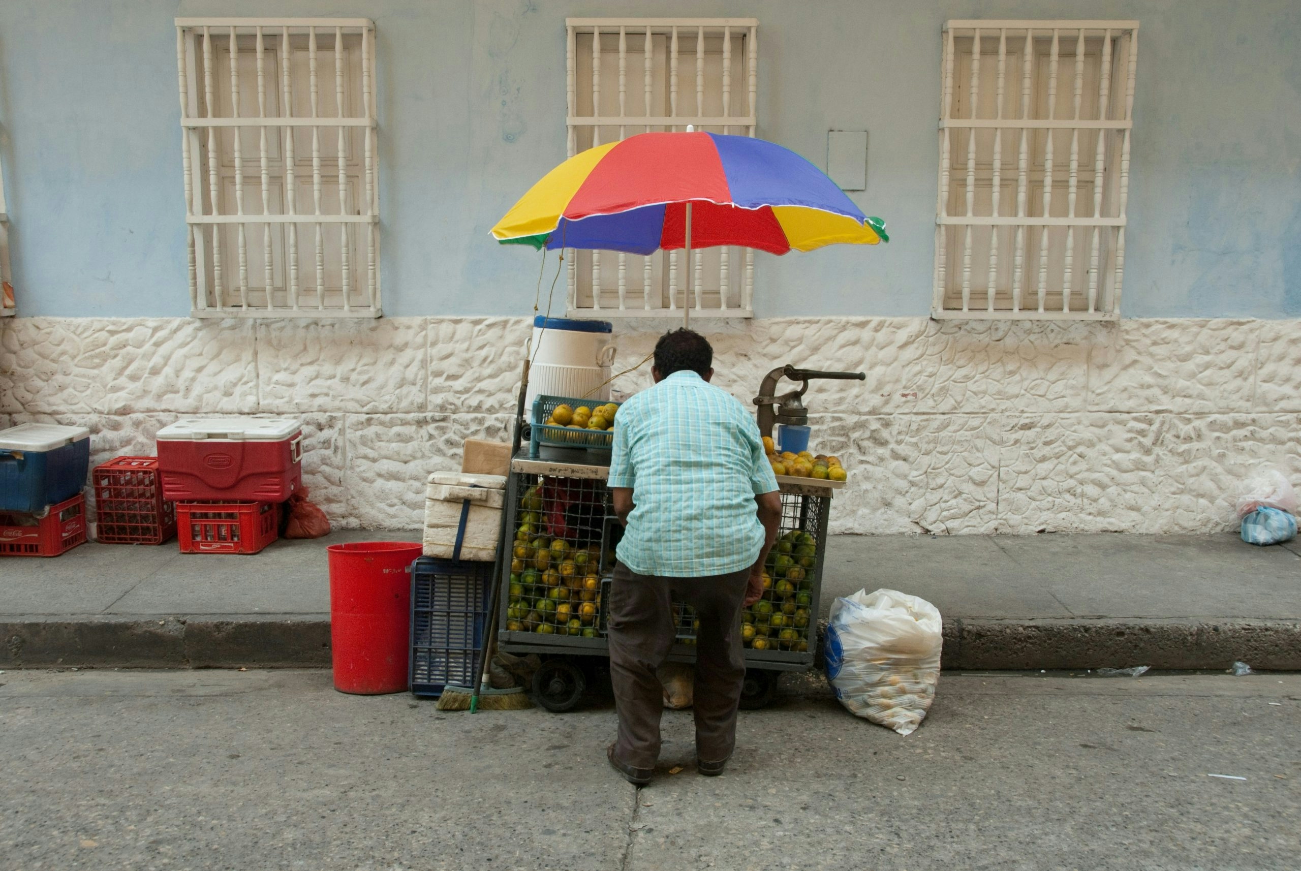Urban street scene in Bogotá featuring a street vendor