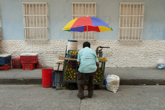 Urban street scene in Bogotá featuring a street vendor