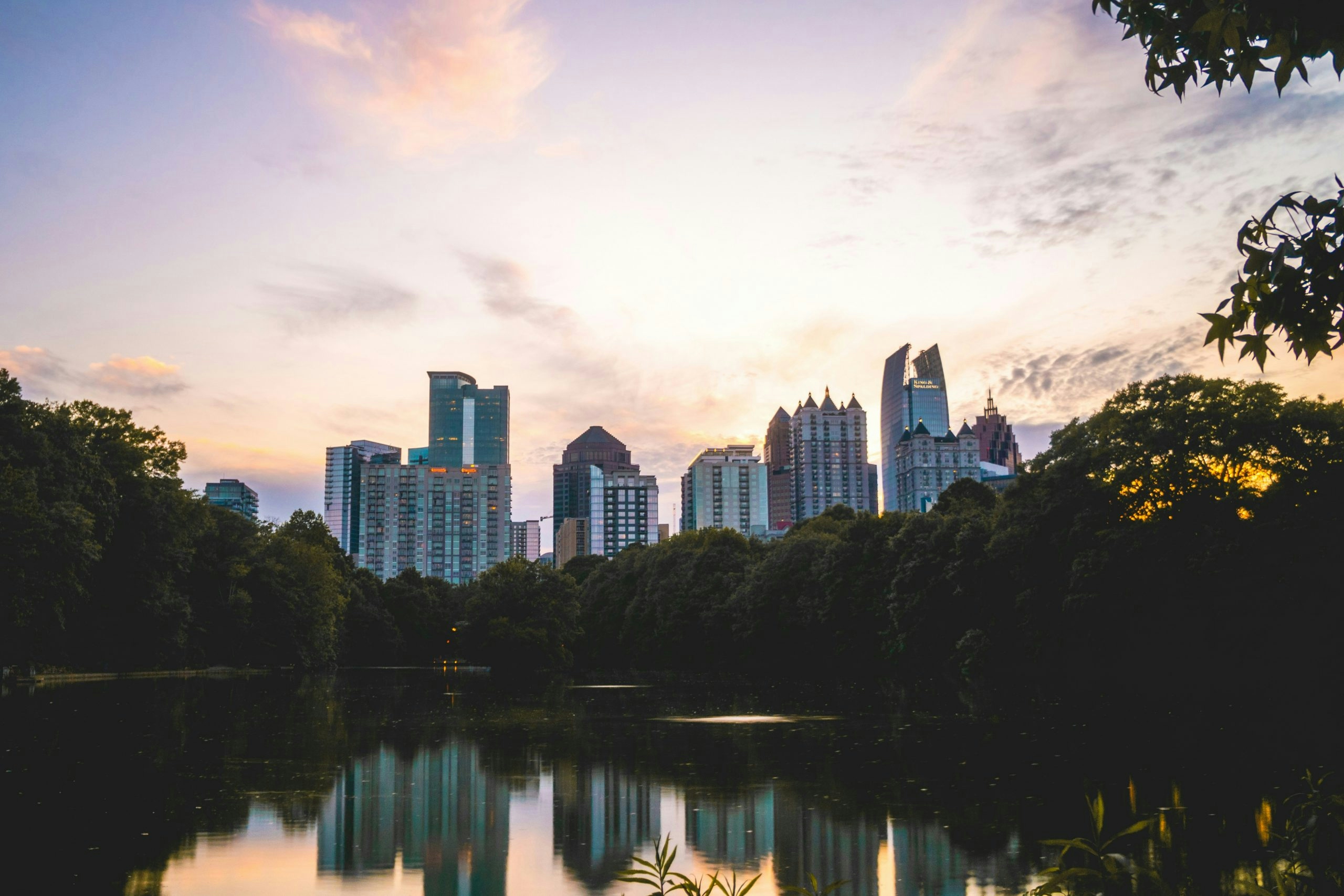 Visitors enjoying Piedmont Park with the Atlanta skyline in the background