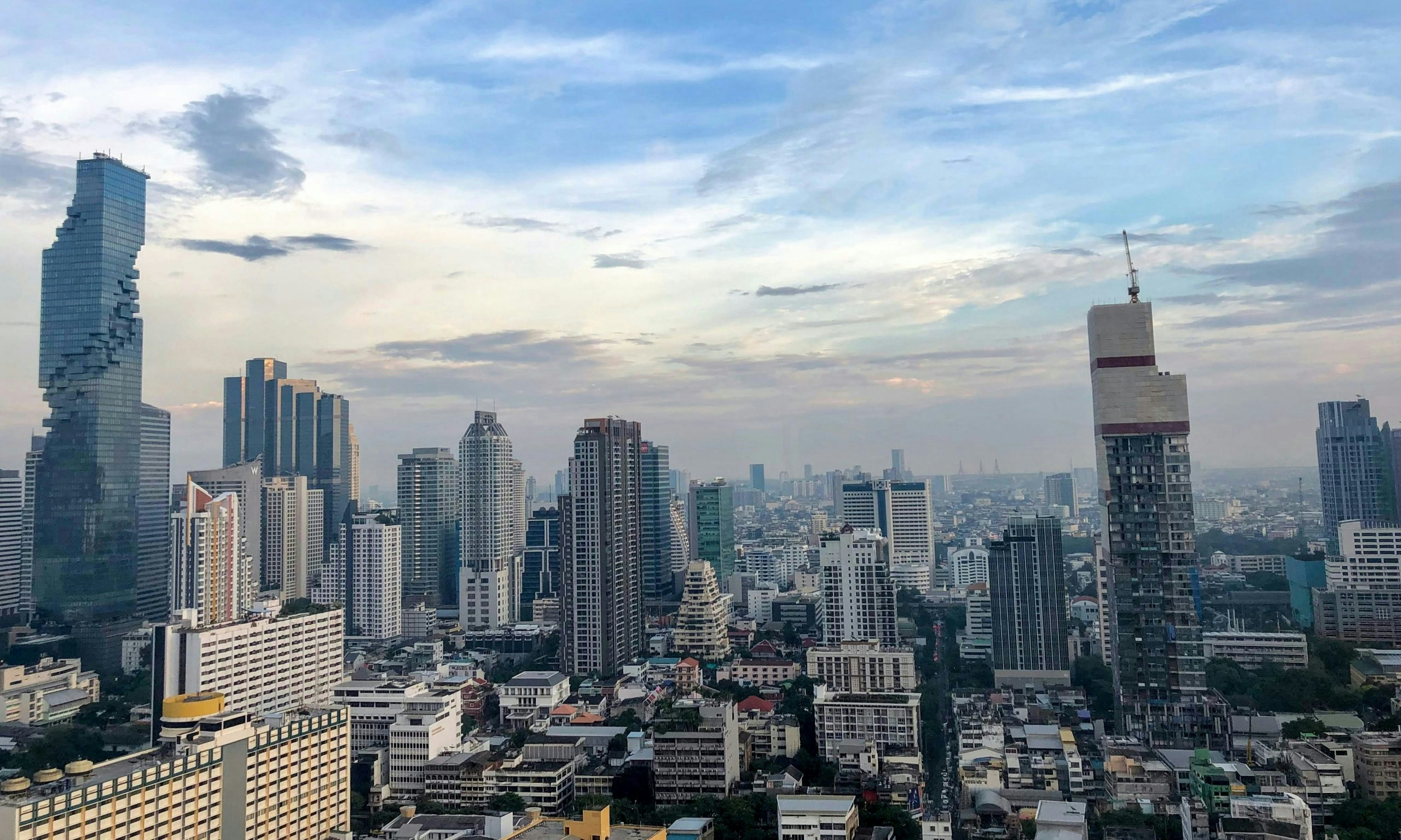 Modern cityscape of Bangkok with towering buildings and urban neighborhoods