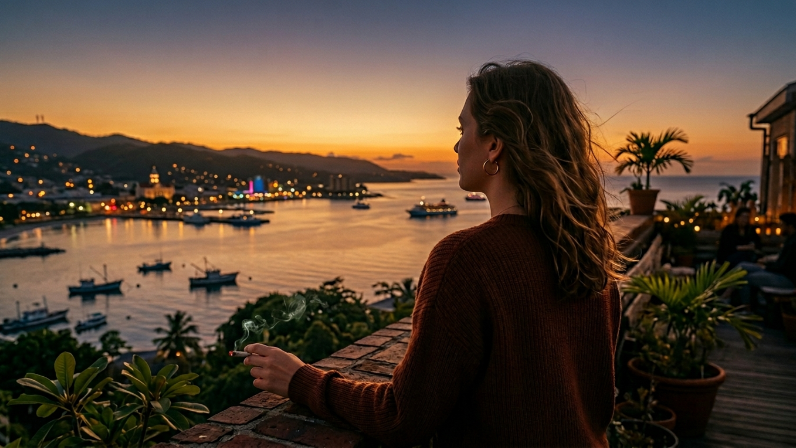 Thoughtful person overlooking illuminated skyline from rooftop in warm dusk haze