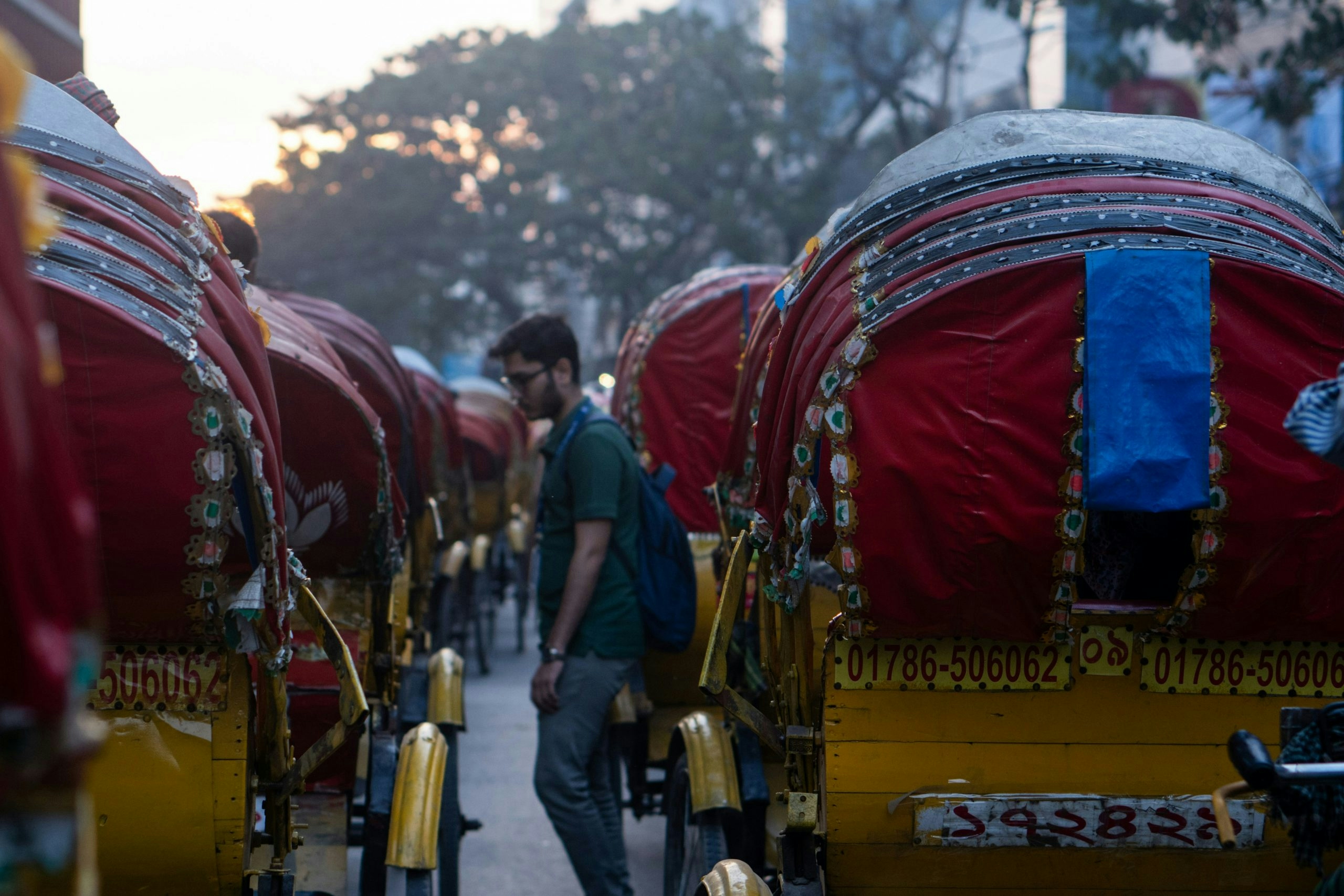 Traditional colorful rickshaw traveling through the streets of Dhaka