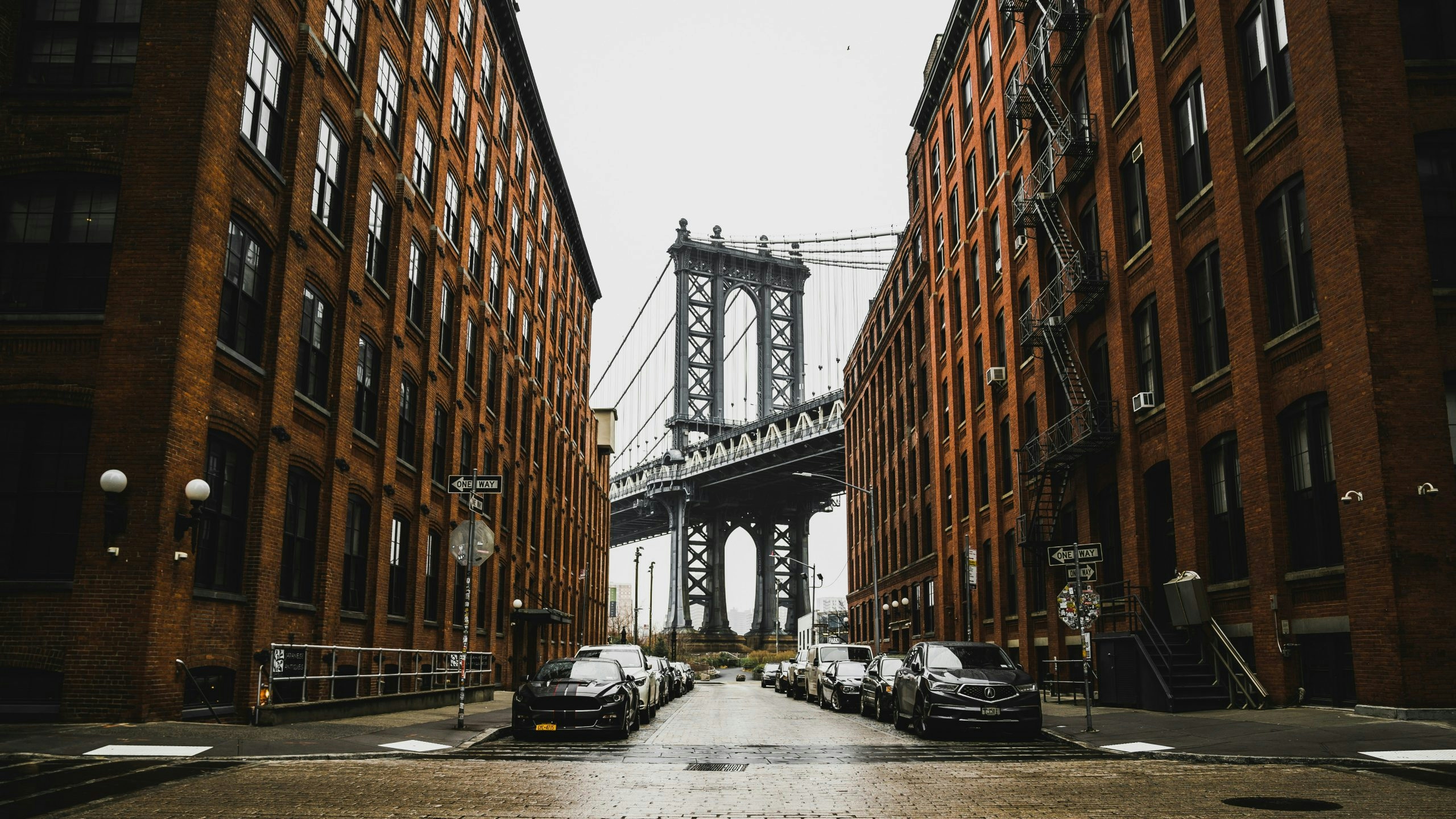 The Brooklyn Bridge connecting Manhattan and Brooklyn on a rainy day