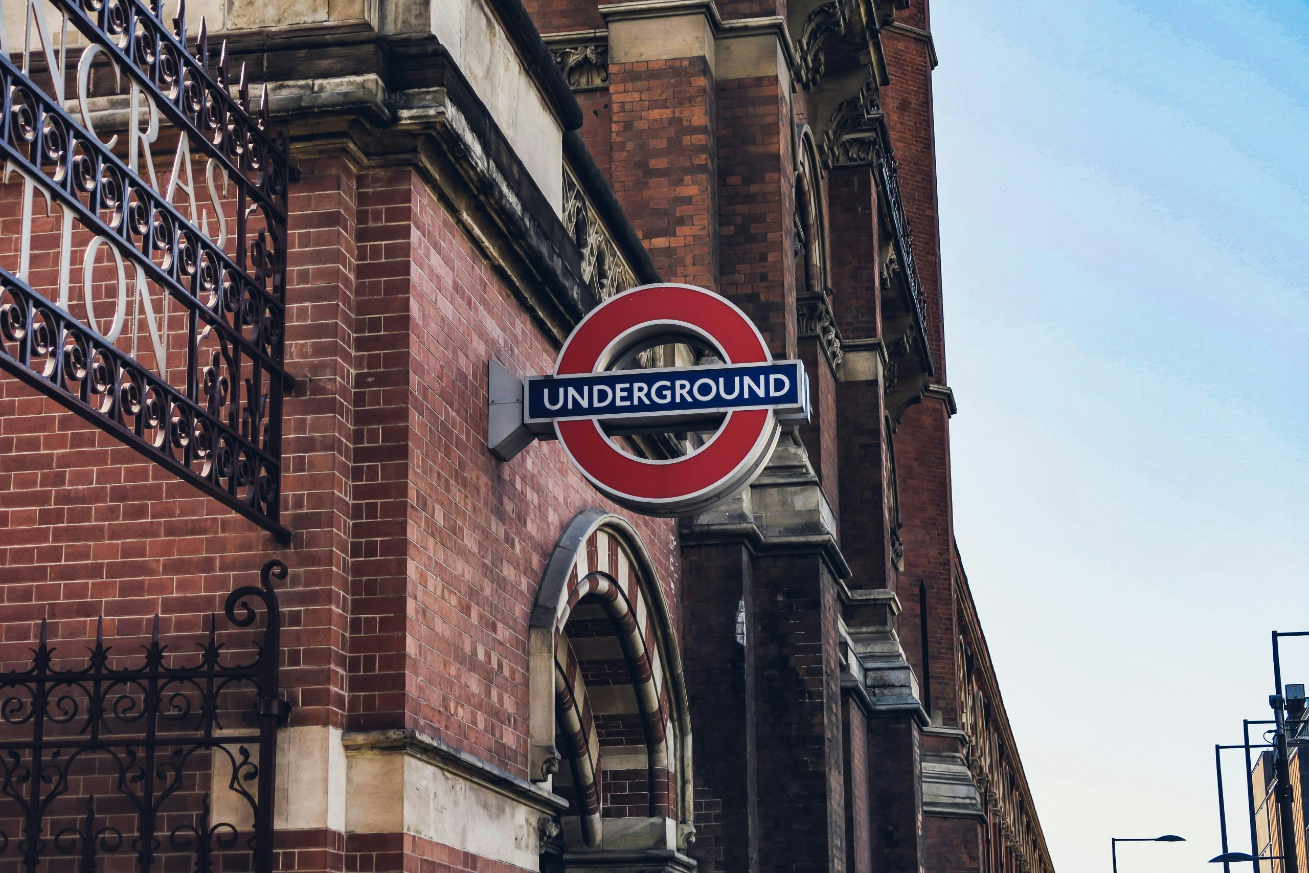 The famous London Underground sign along a busy city street